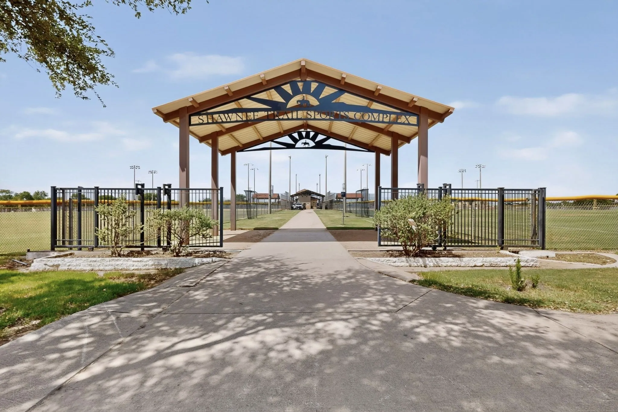 Entrance to the Shawnee Ball Sports Complex, featuring a covered archway with visible signage, decorative metalwork, and concrete pathways