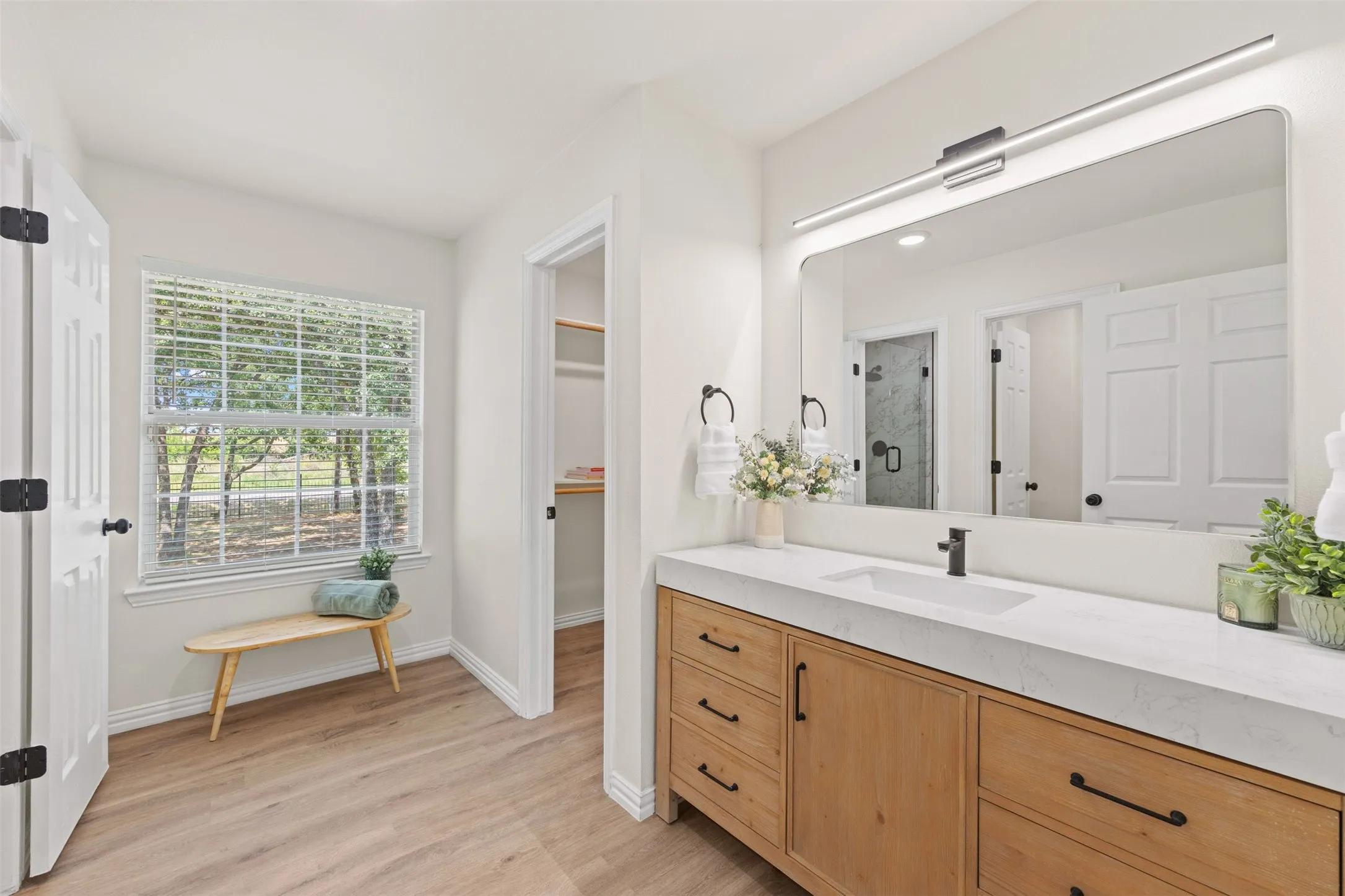 Upstairs bathroom with dual vanity and extra large walk in closet.