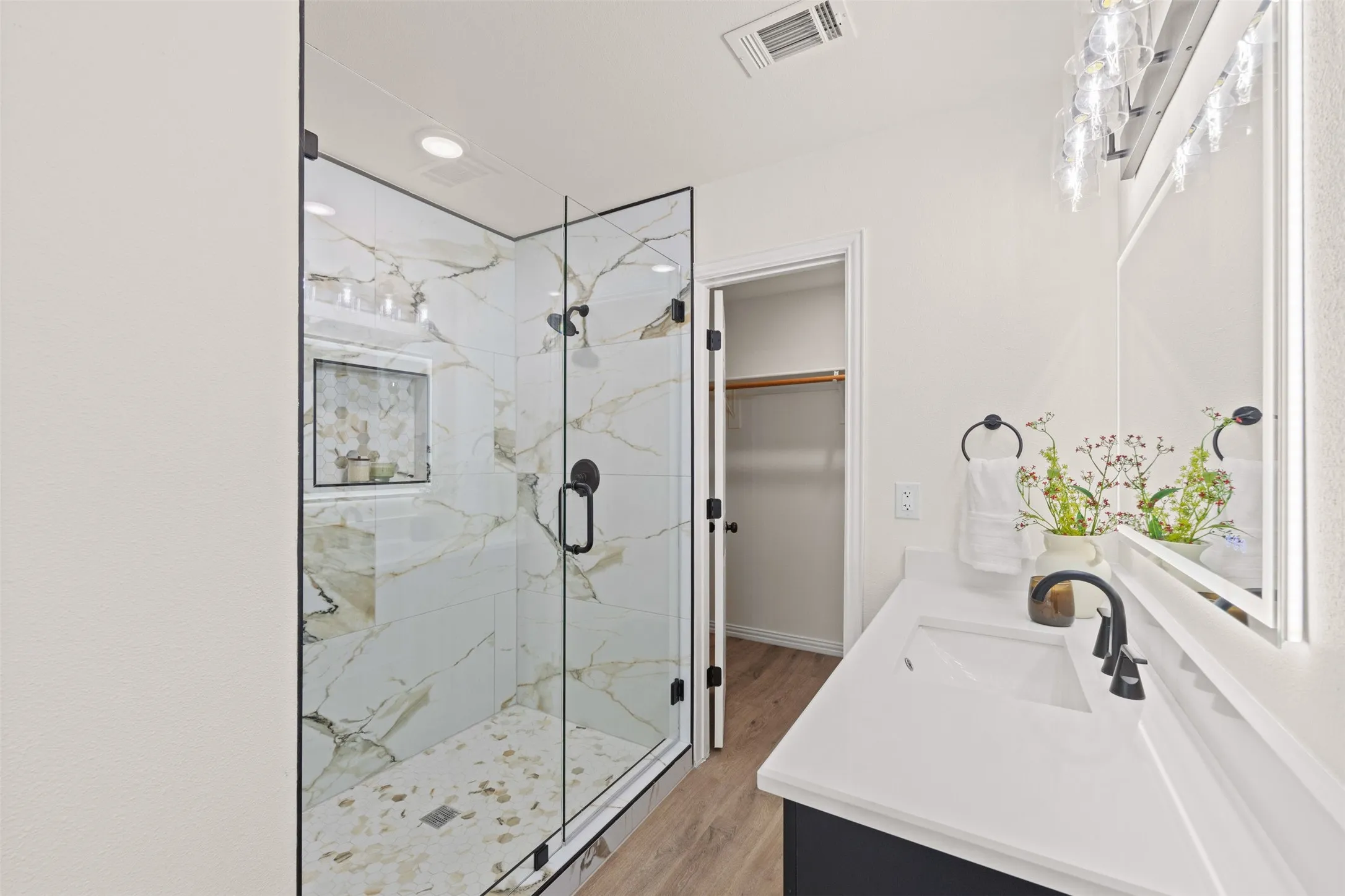 Primary bathroom with dual vanity walk in closet