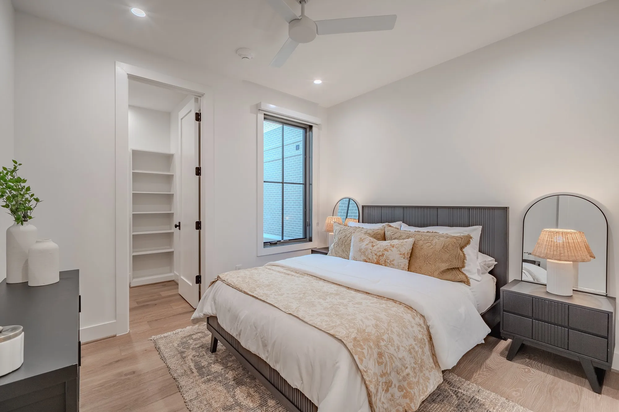 Bedroom featuring a walk in closet, light wood-type flooring, ceiling fan, and recessed lighting