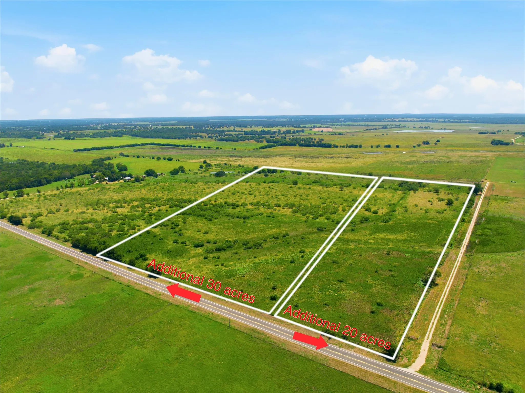 Expansive land parcels featuring verdant fields and scattered natural vegetation
