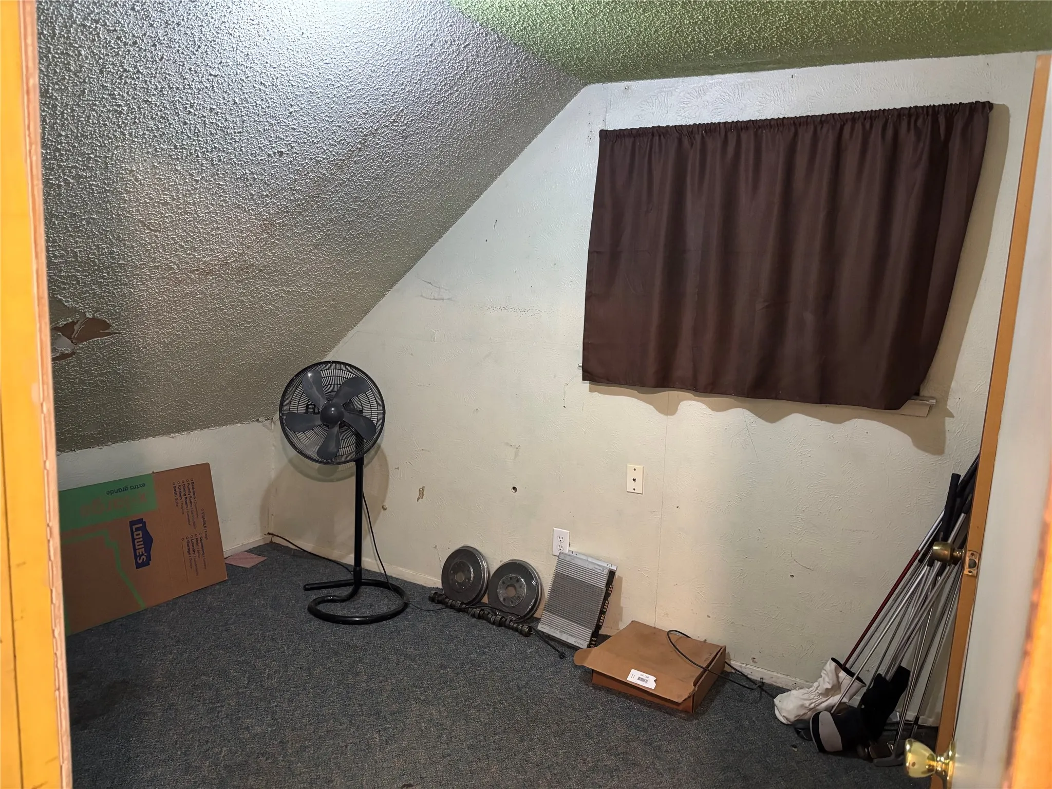 Bedroom featuring sloped ceiling and carpet flooring