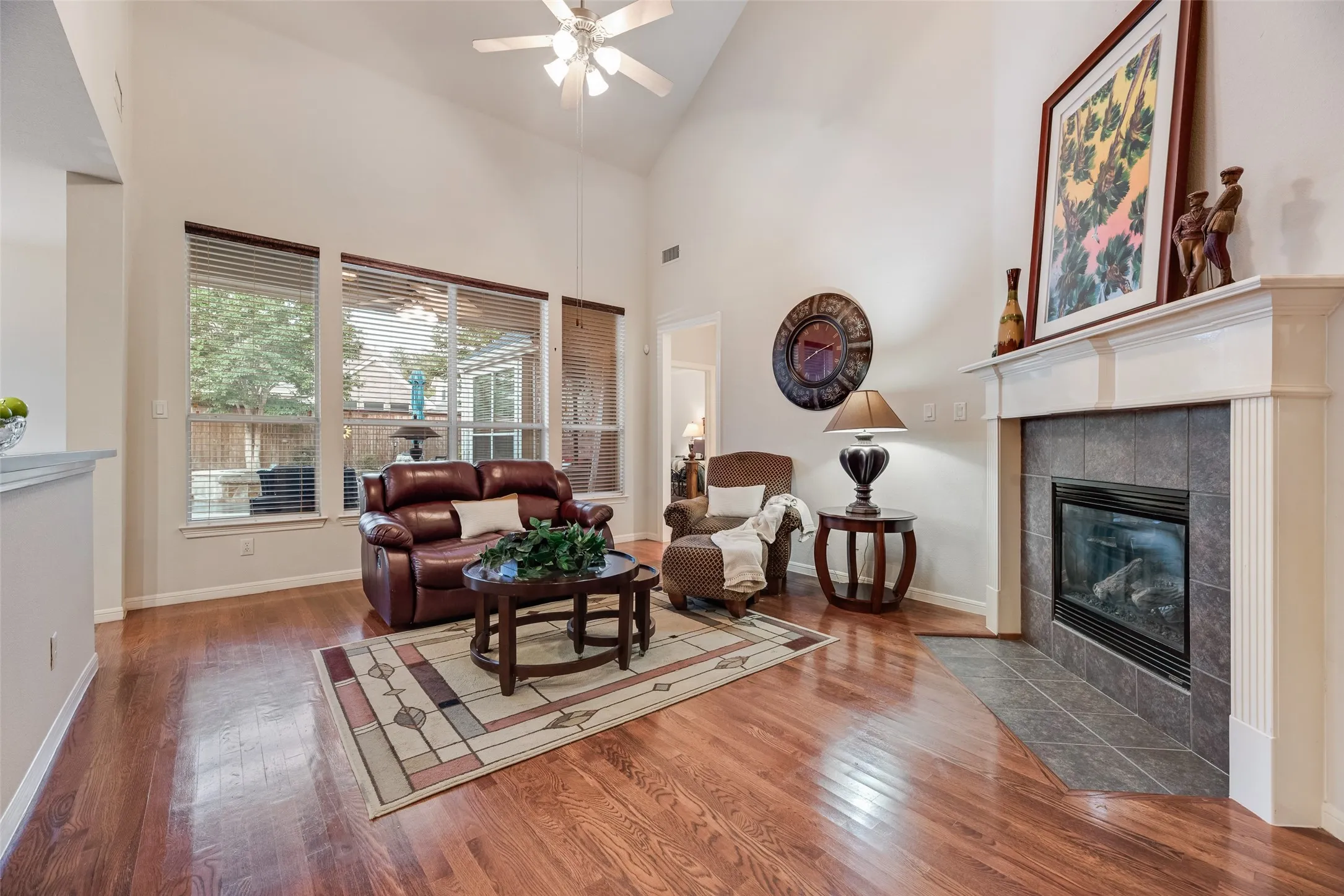 Warm hardwoods continue into the primary living space. The fireplace offers, gas starter and faux logs.