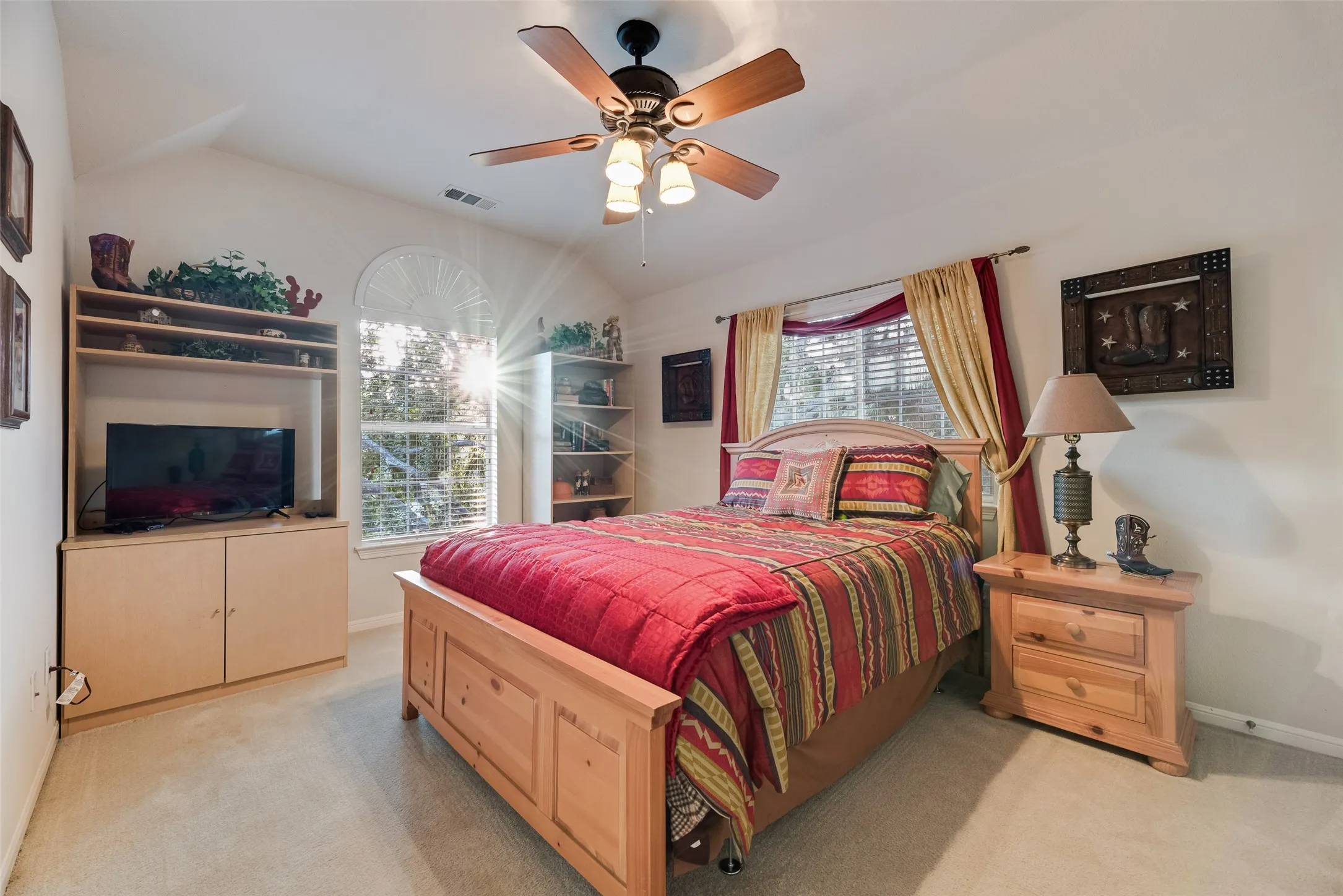 Bedroom four has views of the front yard and enjoys the greenery of the mature tree that waves in the wind.