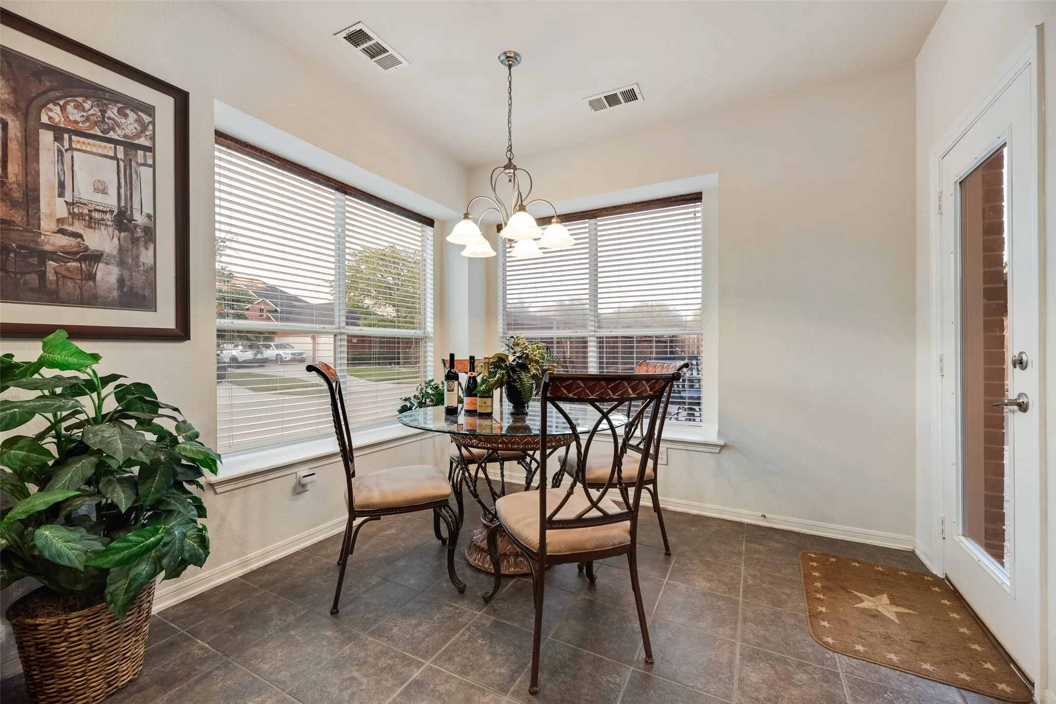 This kitchen nook offers bench seating as well as lots of natural lighting and views of the pool area.
