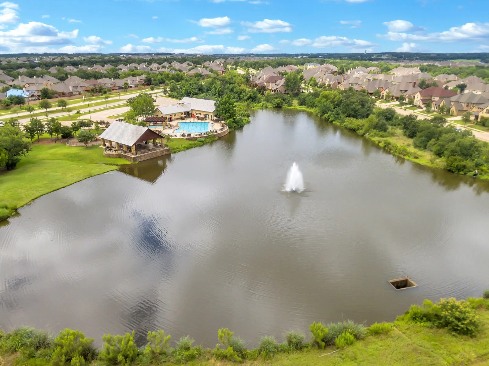 There are fishing ponds, hiking, bike trails, and playgrounds sprinkled throughout the  community. Pictured here is the North amenity center with a catch and release pond, park, fitness center, barbecue pavilion and trail head.