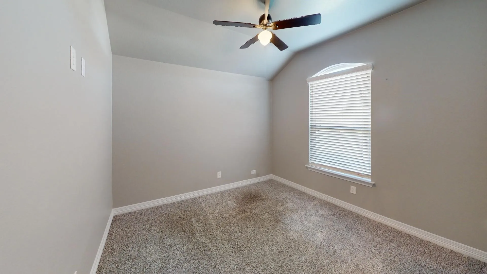 Bedroom 4 featuring carpeting, a ceiling fan with integrated lighting, and an arched window with blinds