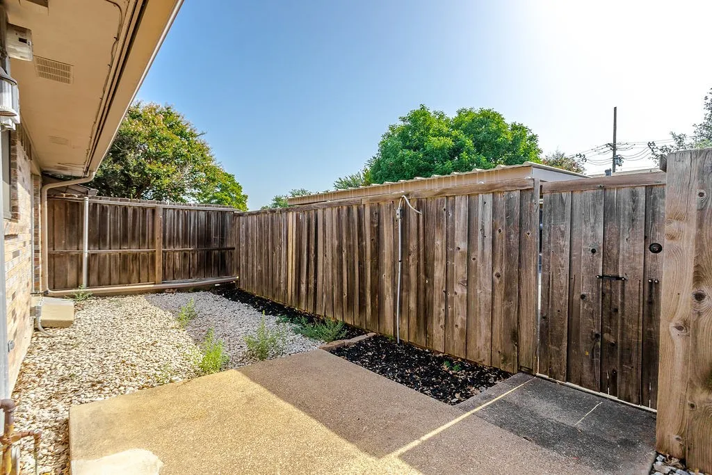 Private fence patio - can see the roof of the 2 car carport above the fence line.