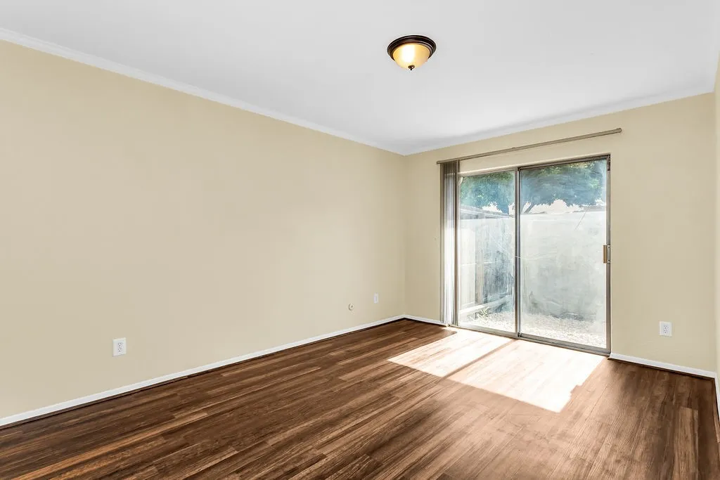 Bedroom #2 Wood-finish flooring with a neutral wall palette