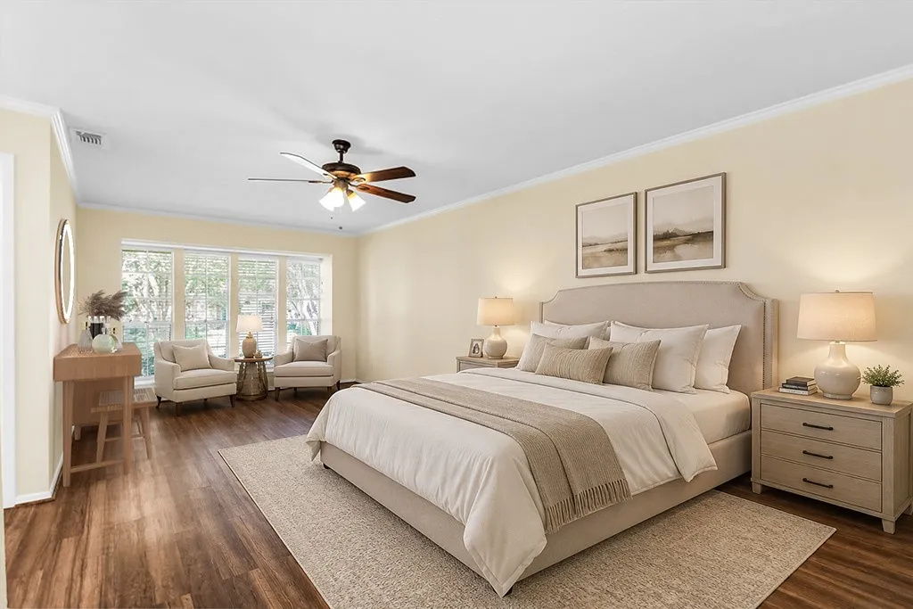 Virtually staged Spacious room featuring wood-finish flooring, light-toned walls, and white crown molding