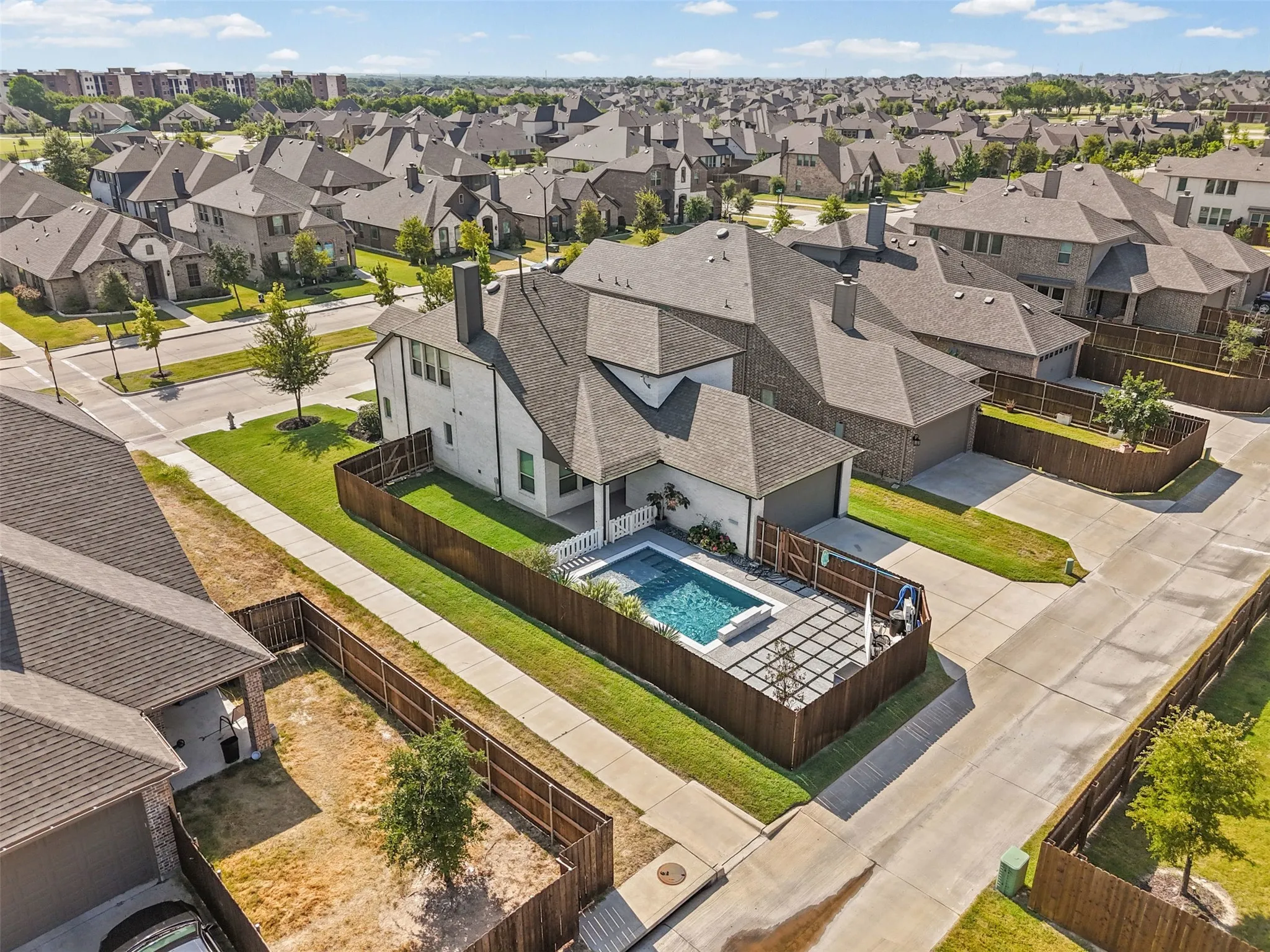 Modern exterior with a private swimming pool, fenced backyard, and established landscaping