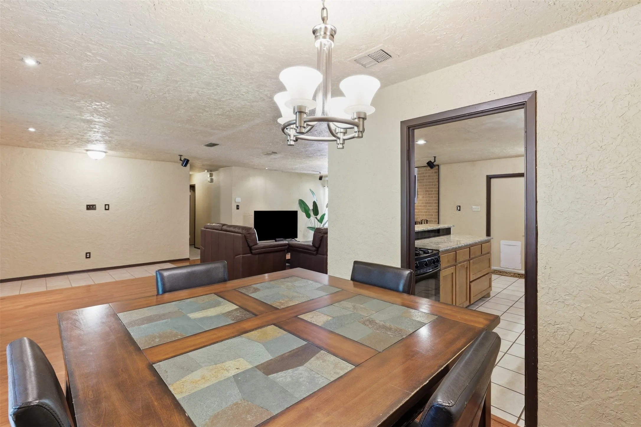 Flexible dining area with wood flooring and convenient access to the kitchen and open living spaces—ideal for dining, entertaining, or a home workspace