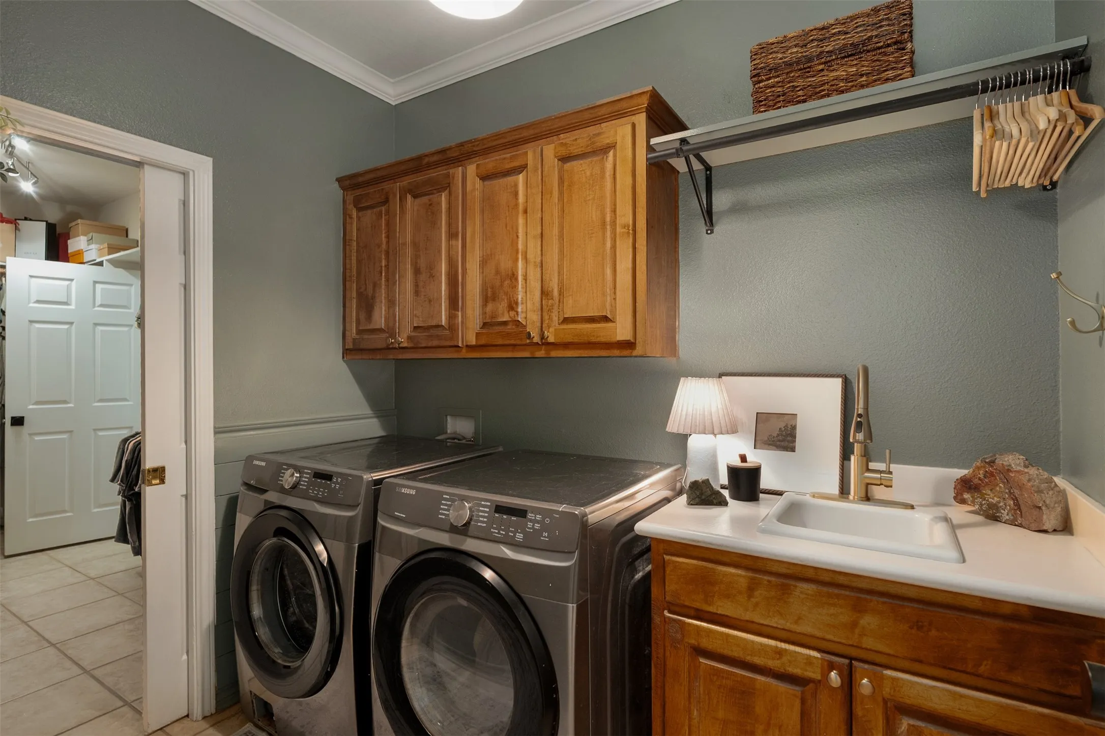 laundry room with sink conveniently connected to primary closet