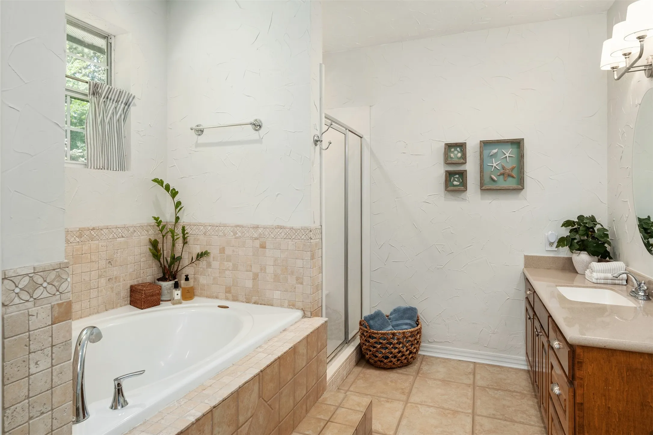 primary bathroom with separate tub and shower