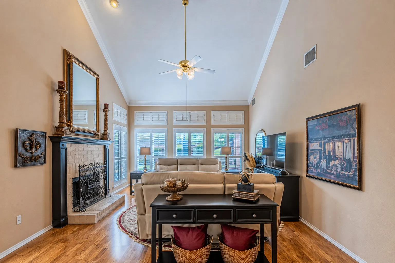 Spacious living room with plantation shutters and views of the amazing backyard