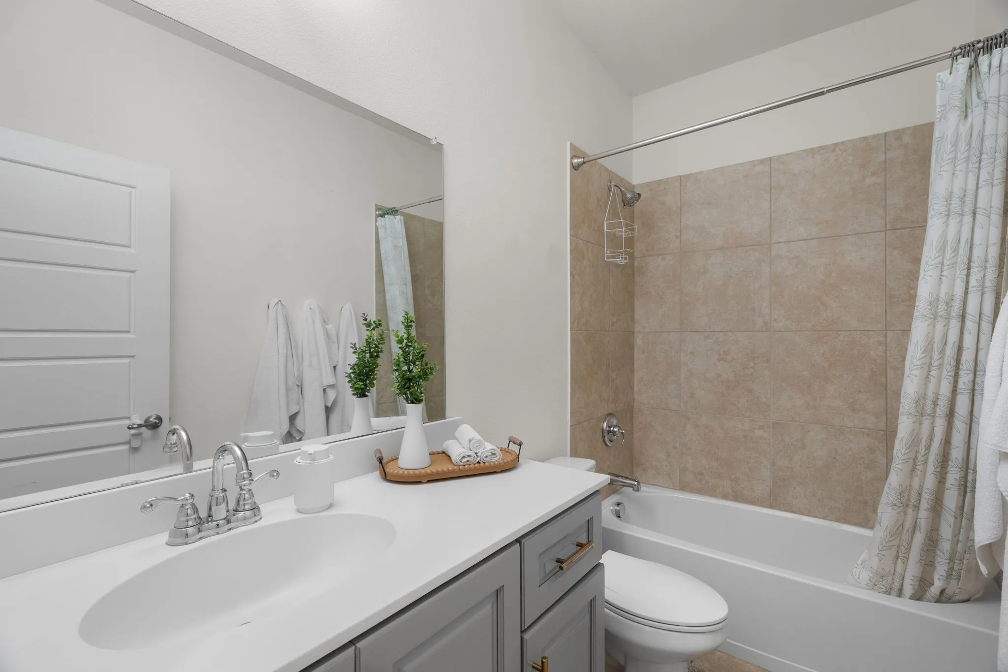 Bathroom featuring a gray vanity with a white countertop and integrated sink