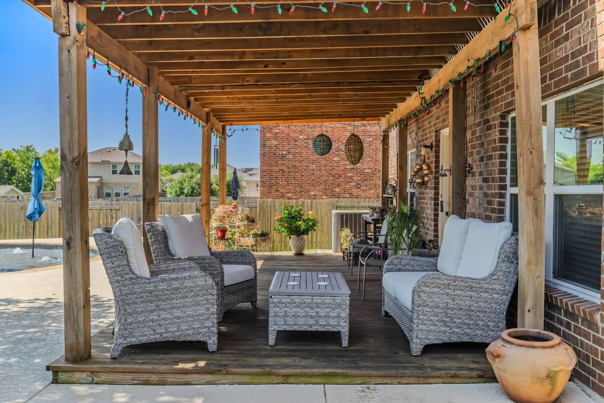 Covered deck extends across back of house