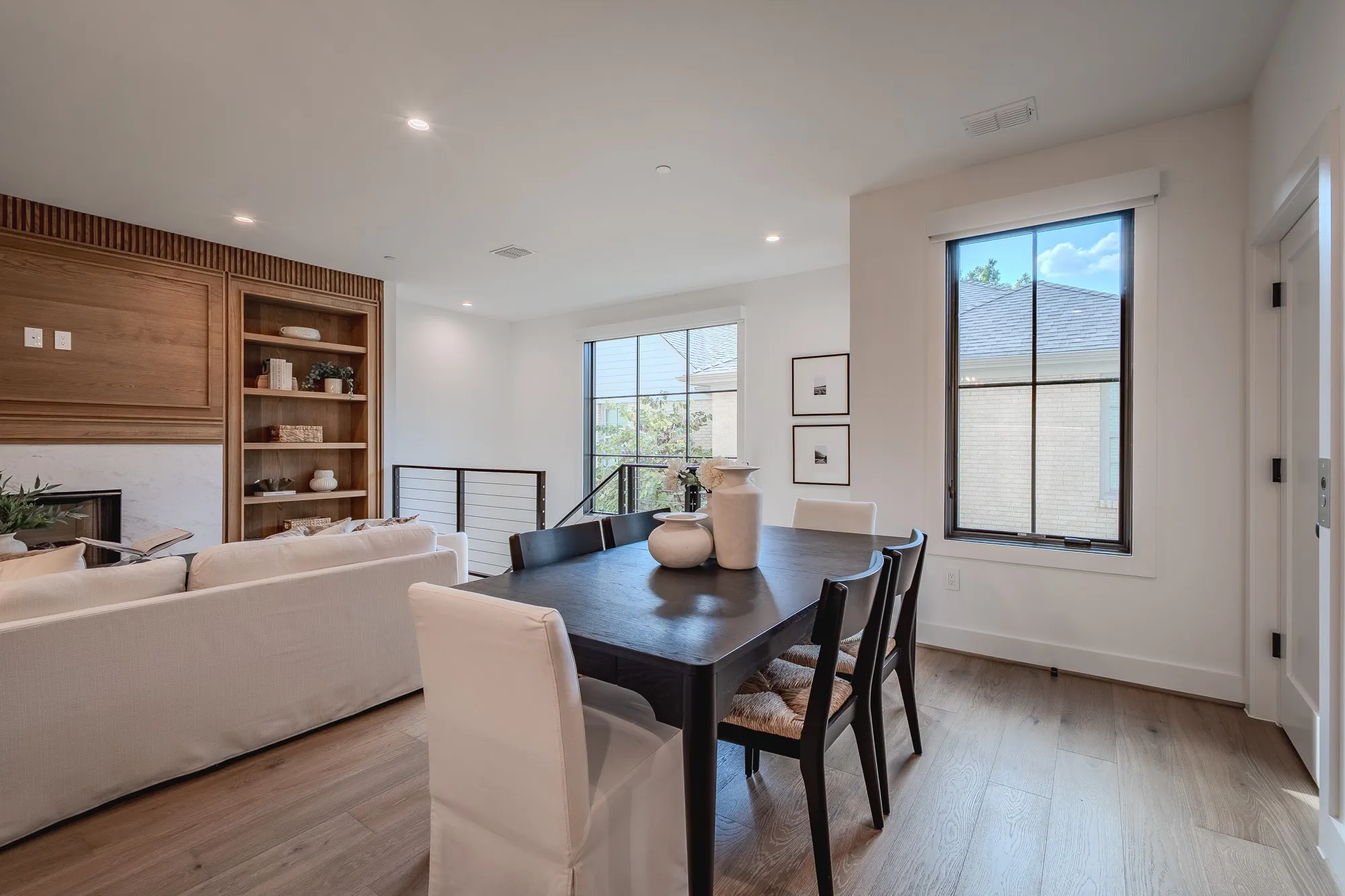 Dining area featuring plenty of natural light, light wood-type flooring, recessed lighting, and a glass covered fireplace