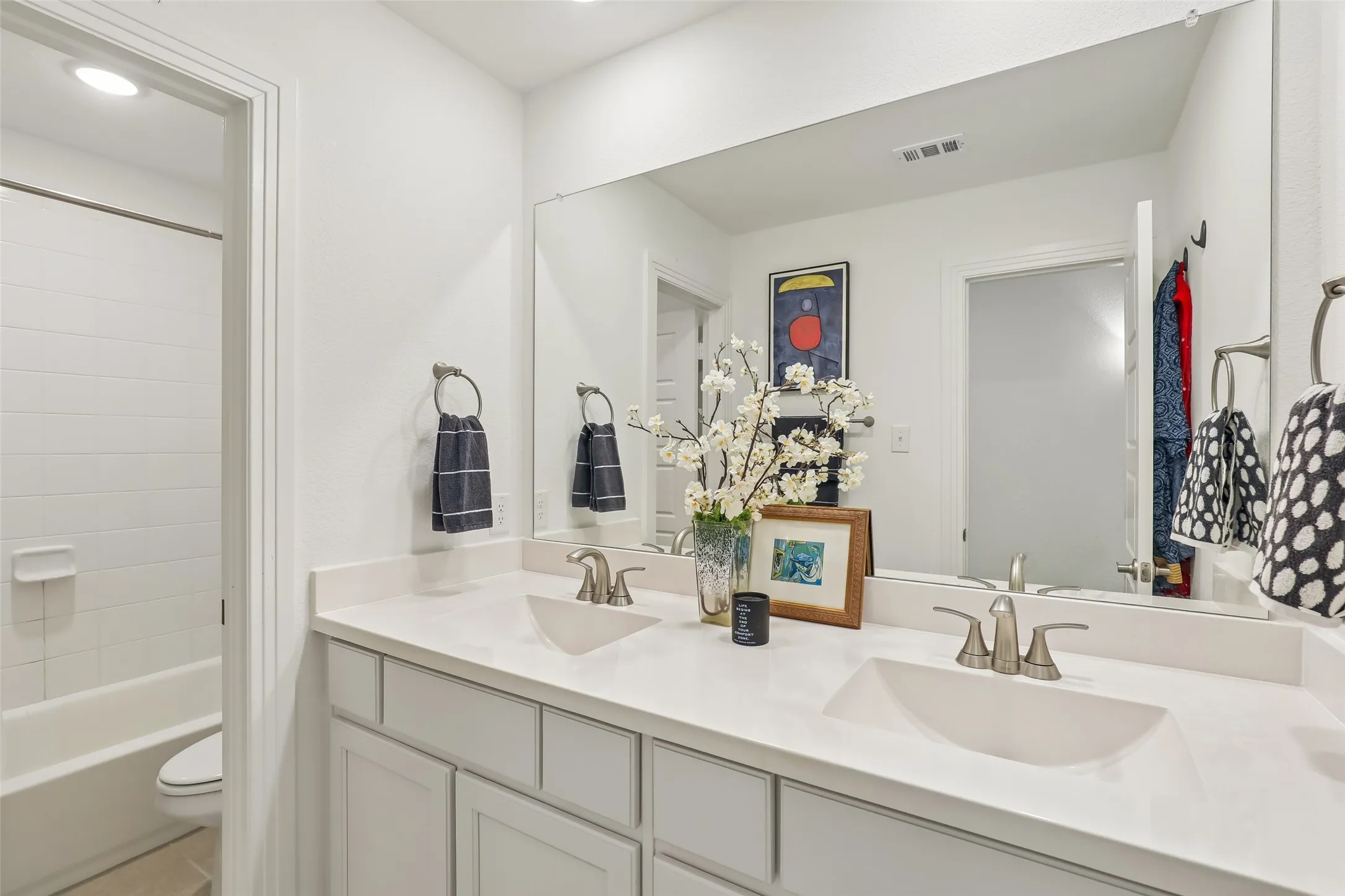 Bathroom with dual sinks between upsatirs bedrooms