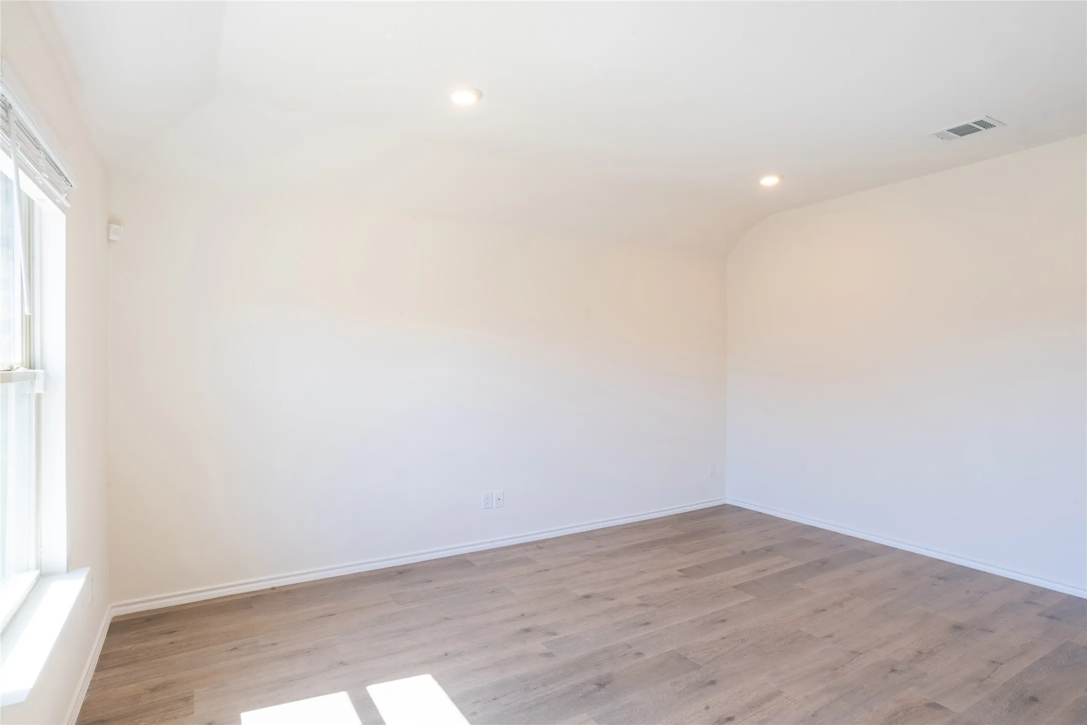 Living room featuring recessed lighting, lofted ceiling, and wood finished floors