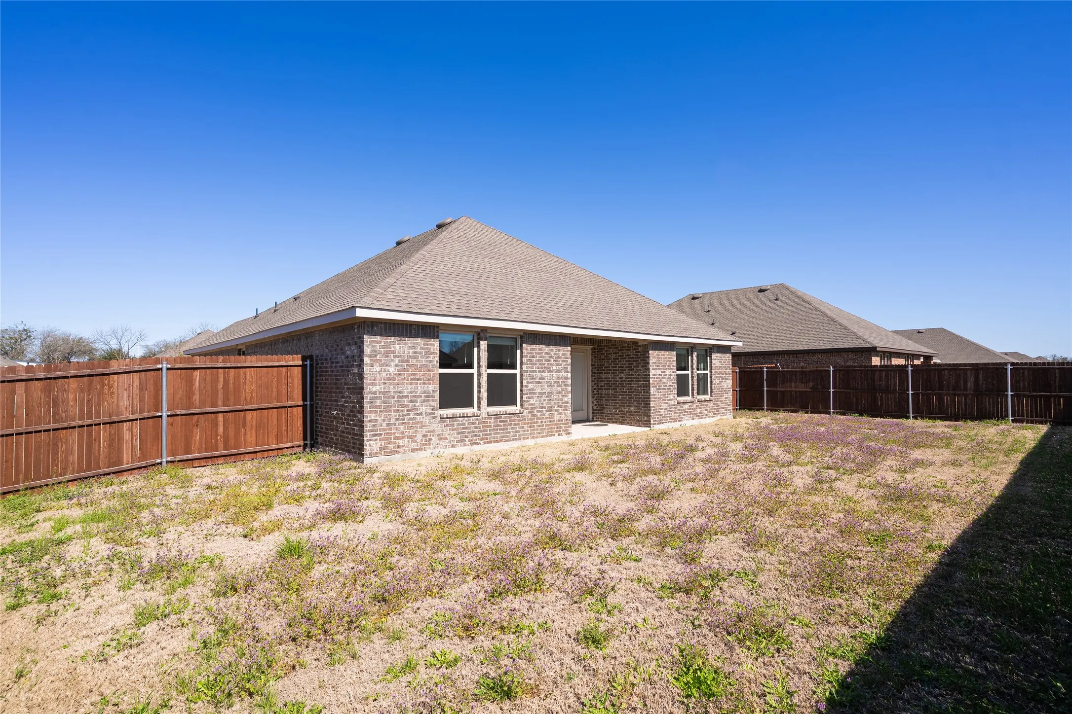 Back of house featuring a fenced backyard
