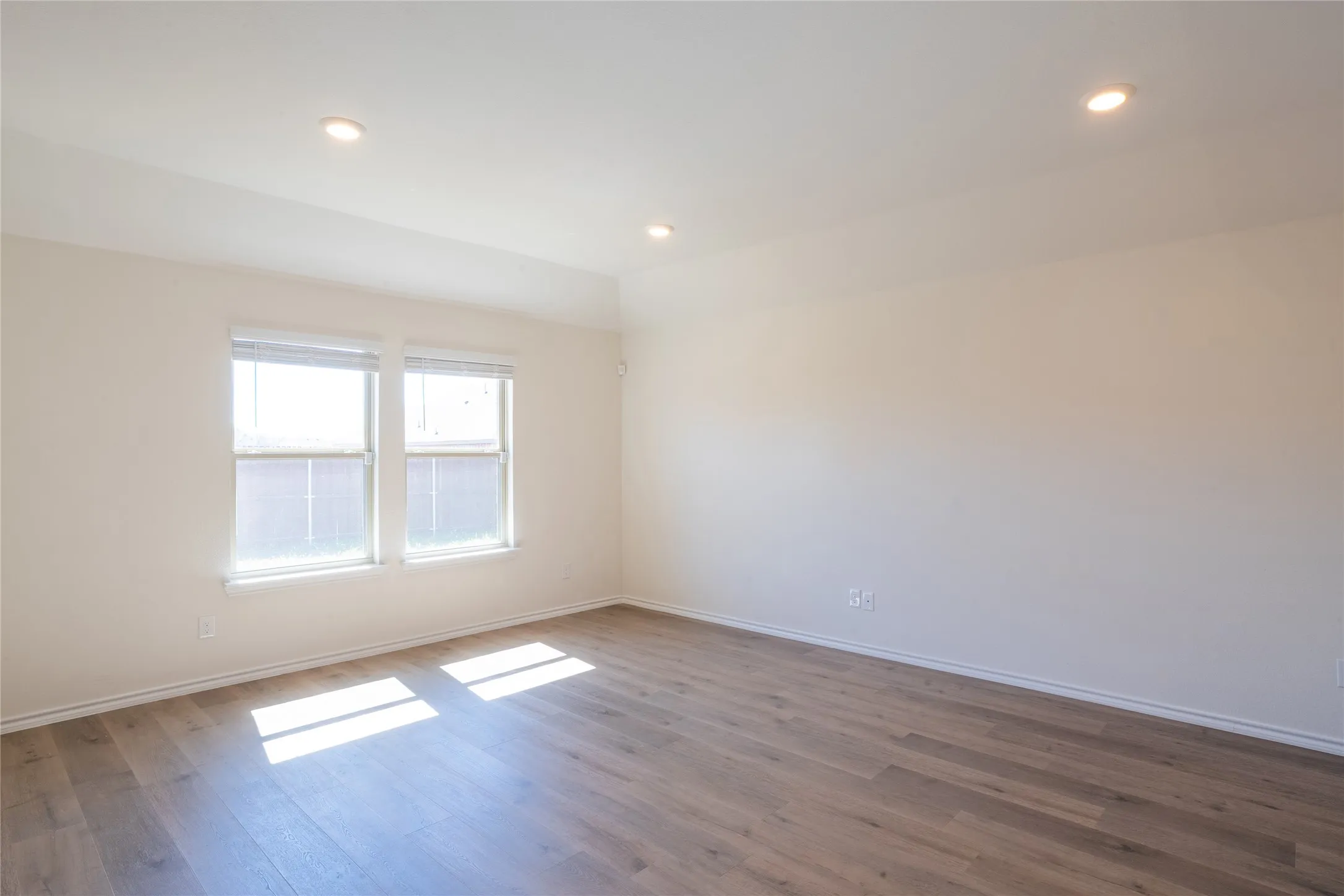 Living room featuring recessed lighting, lofted ceiling, and wood finished floors