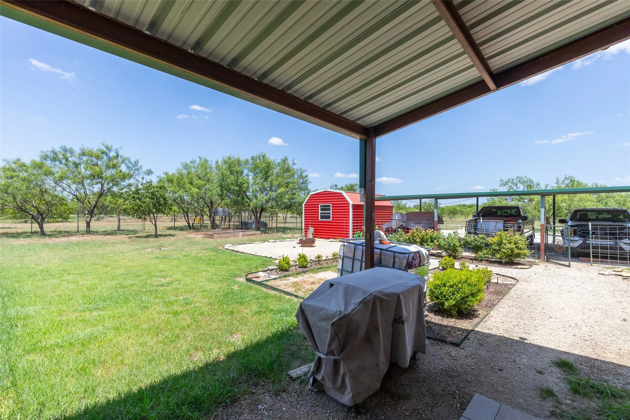 Fenced back yard, gardens, storage, carport for three vehicles and plenty of room for everything else.