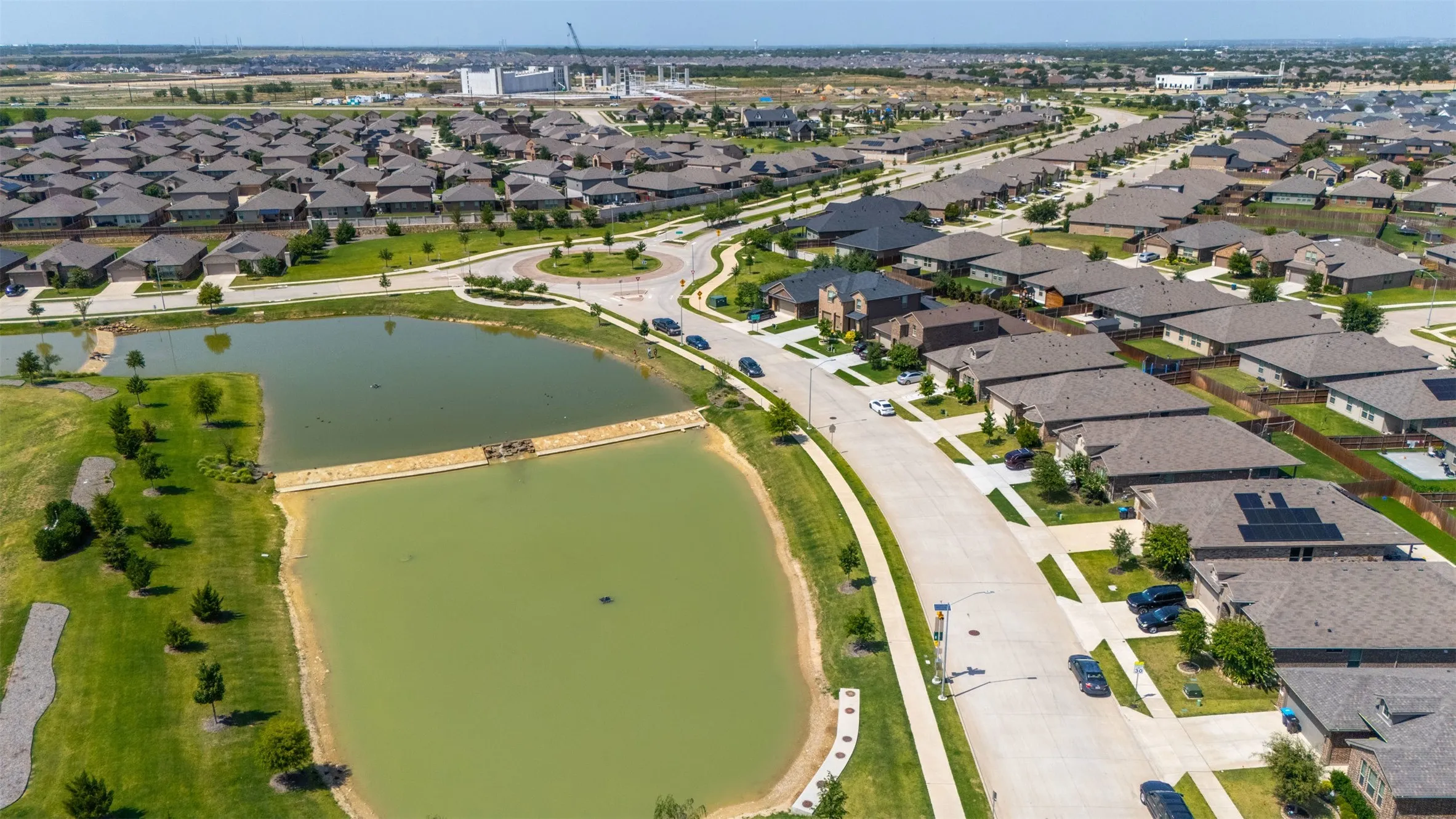 Aerial perspective showcasing a residential community with numerous single-story homes