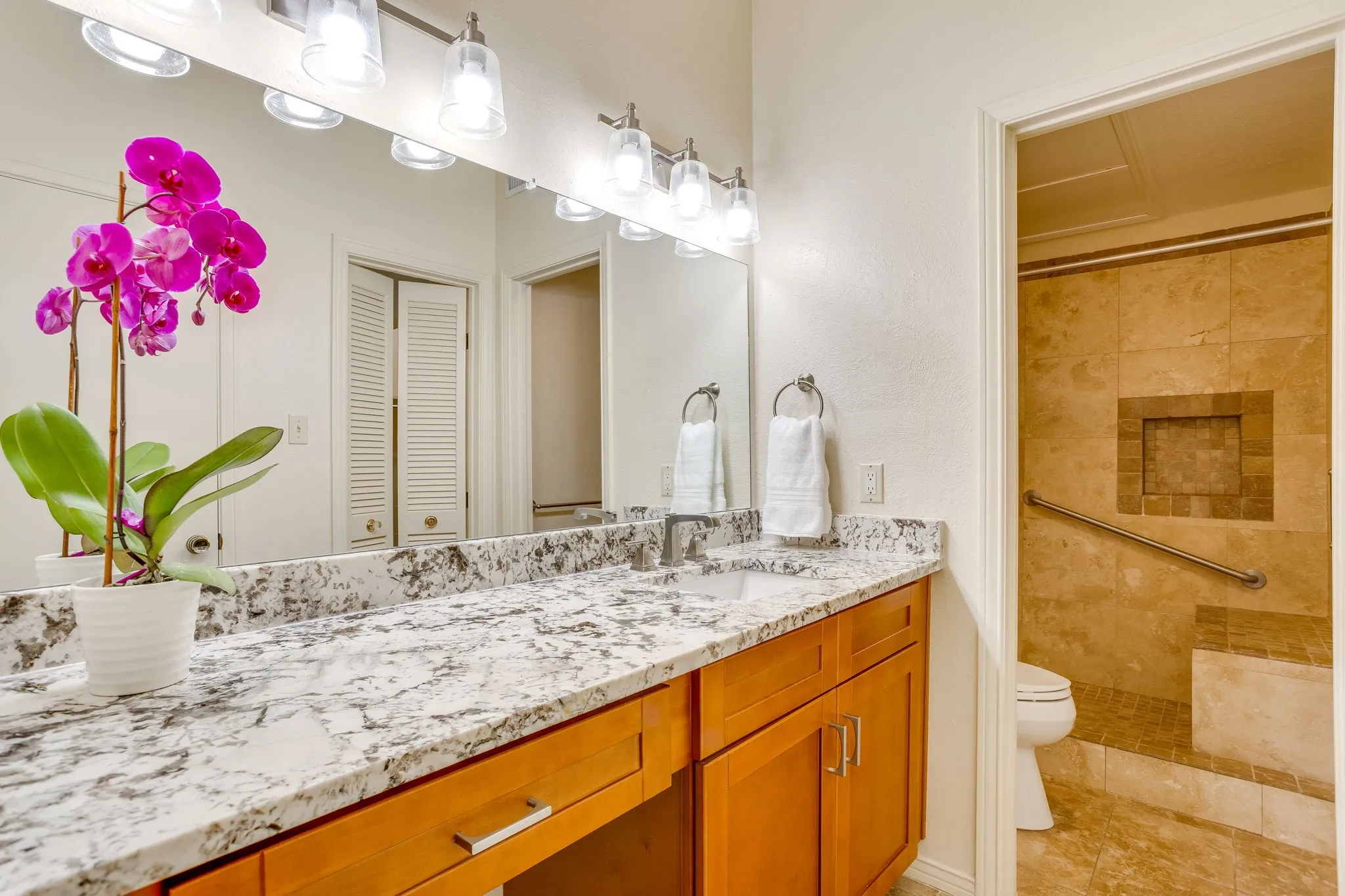 Primary ensuite bathroom with a walk-in shower new cabinets and granite counter tops and a huge walk in closet!!