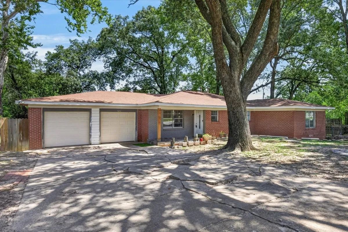 Red brick exterior with a two-car garage