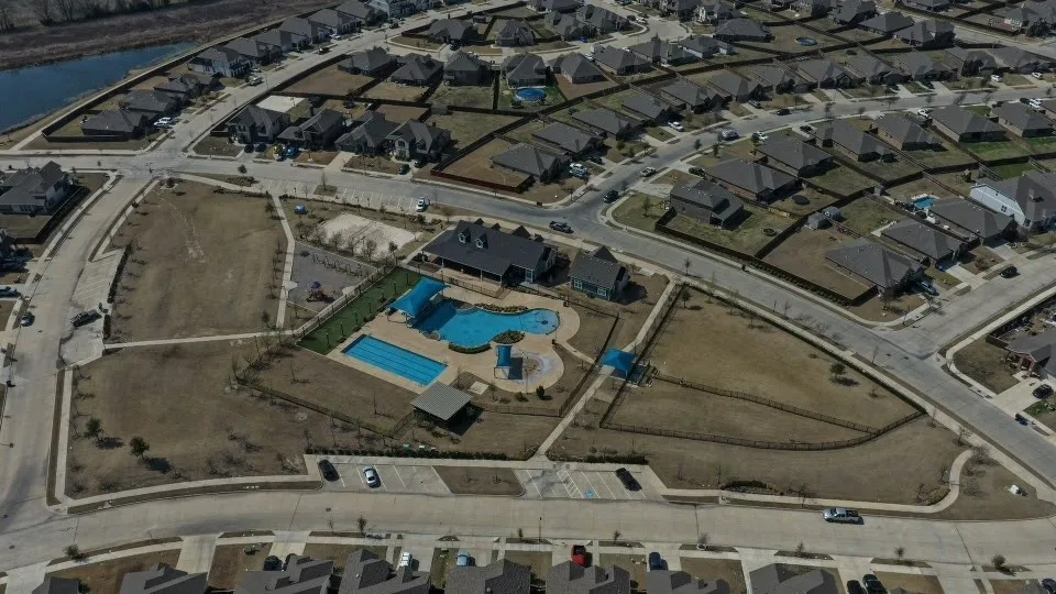 Aerial perspective showcasing a residential community with a large central amenity area