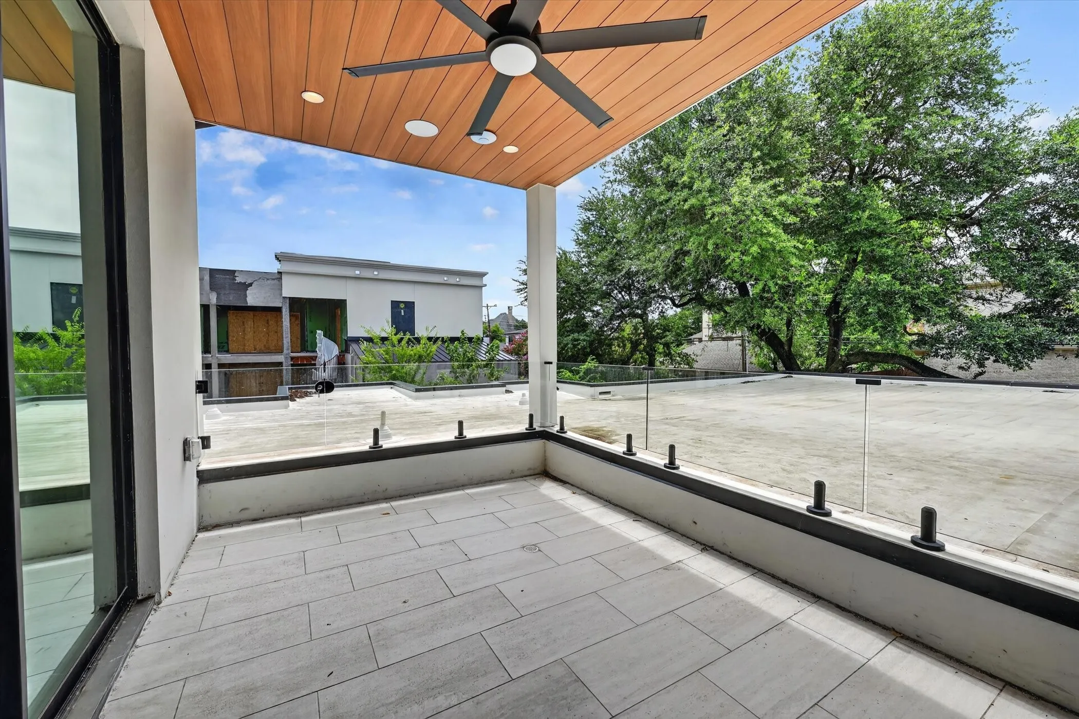 Outdoor covered patio featuring wood-finish ceiling, recessed lighting, and a ceiling fan
