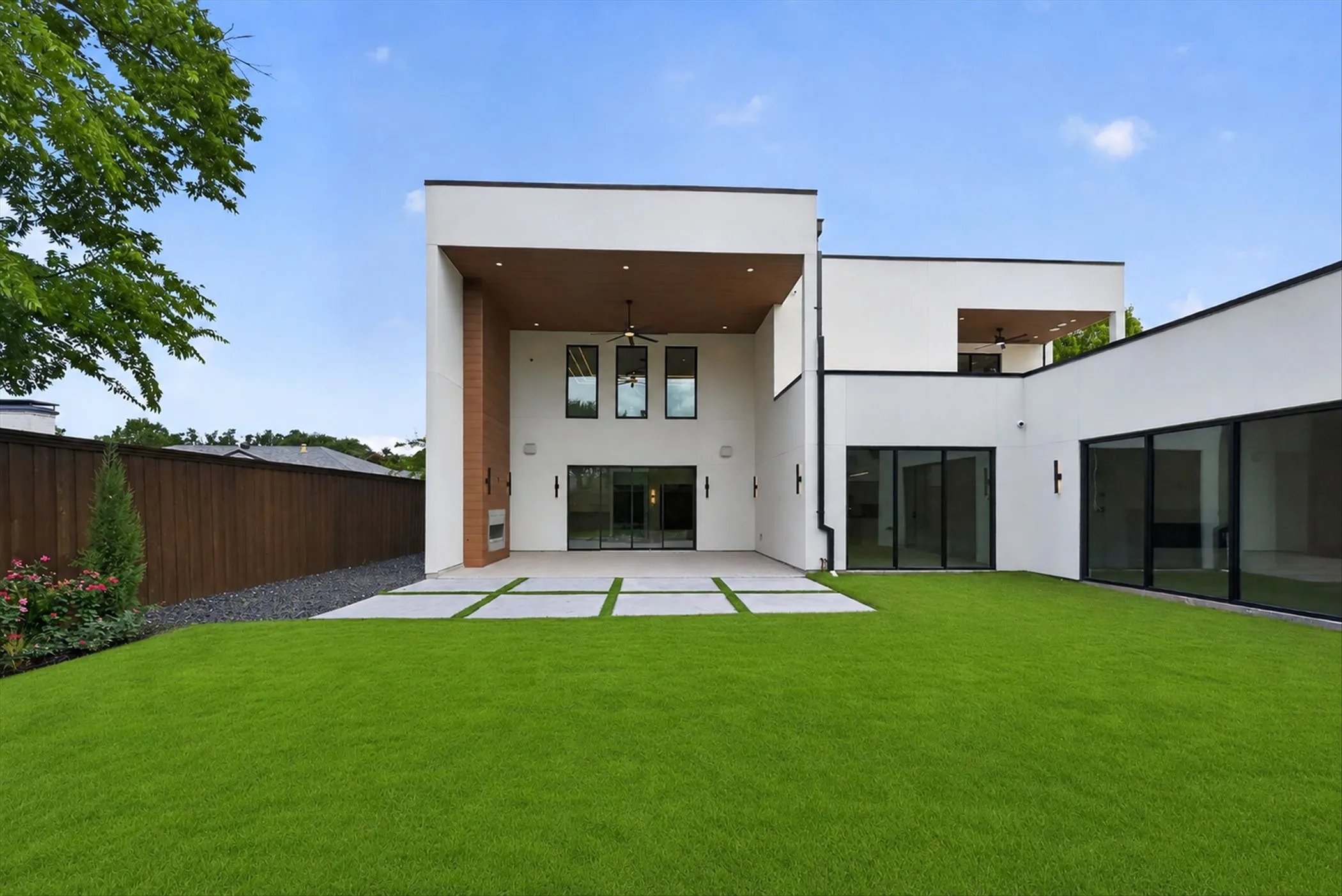 Modern exterior with white stucco finish and black trim