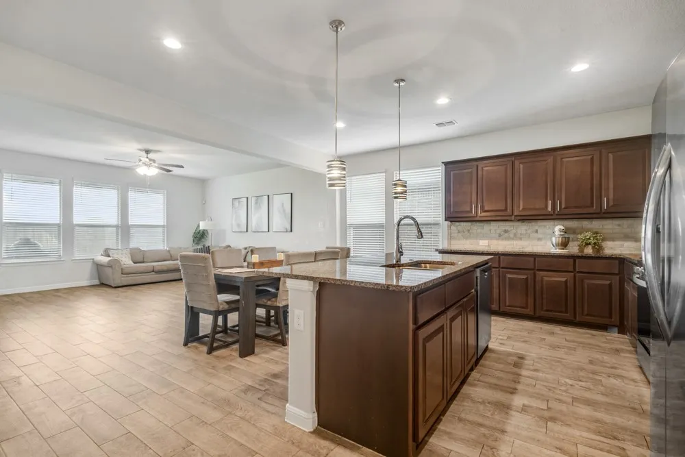 Open-concept living space with wood-finish flooring