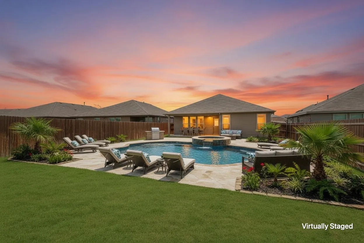 Backyard oasis featuring a curvilinear swimming pool with an integrated fire pit, extensive stone paver patio, lush landscaping, and a substantial lawn area
