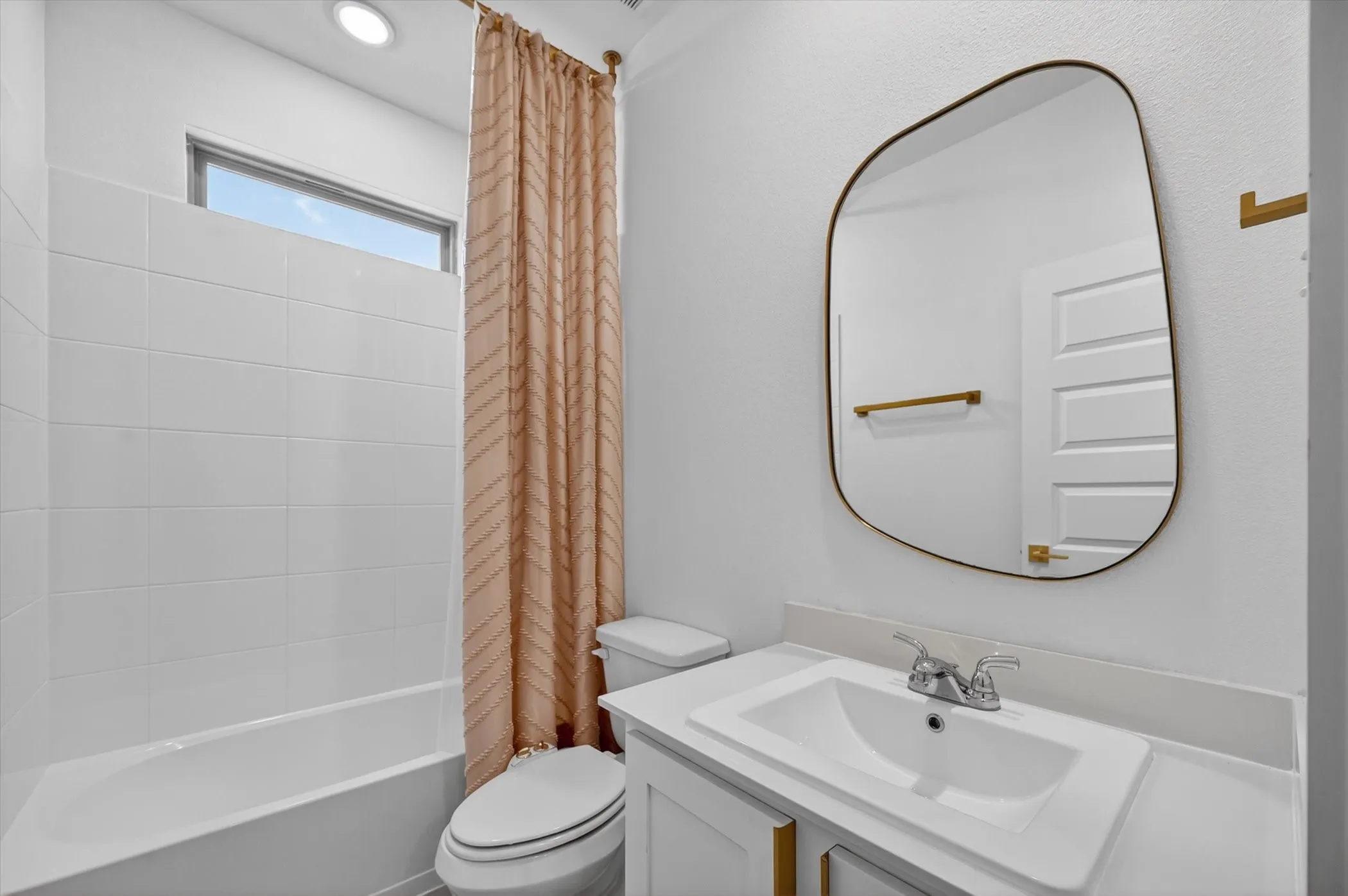 Bathroom featuring a white bathtub, tiled shower surround, and high-set window