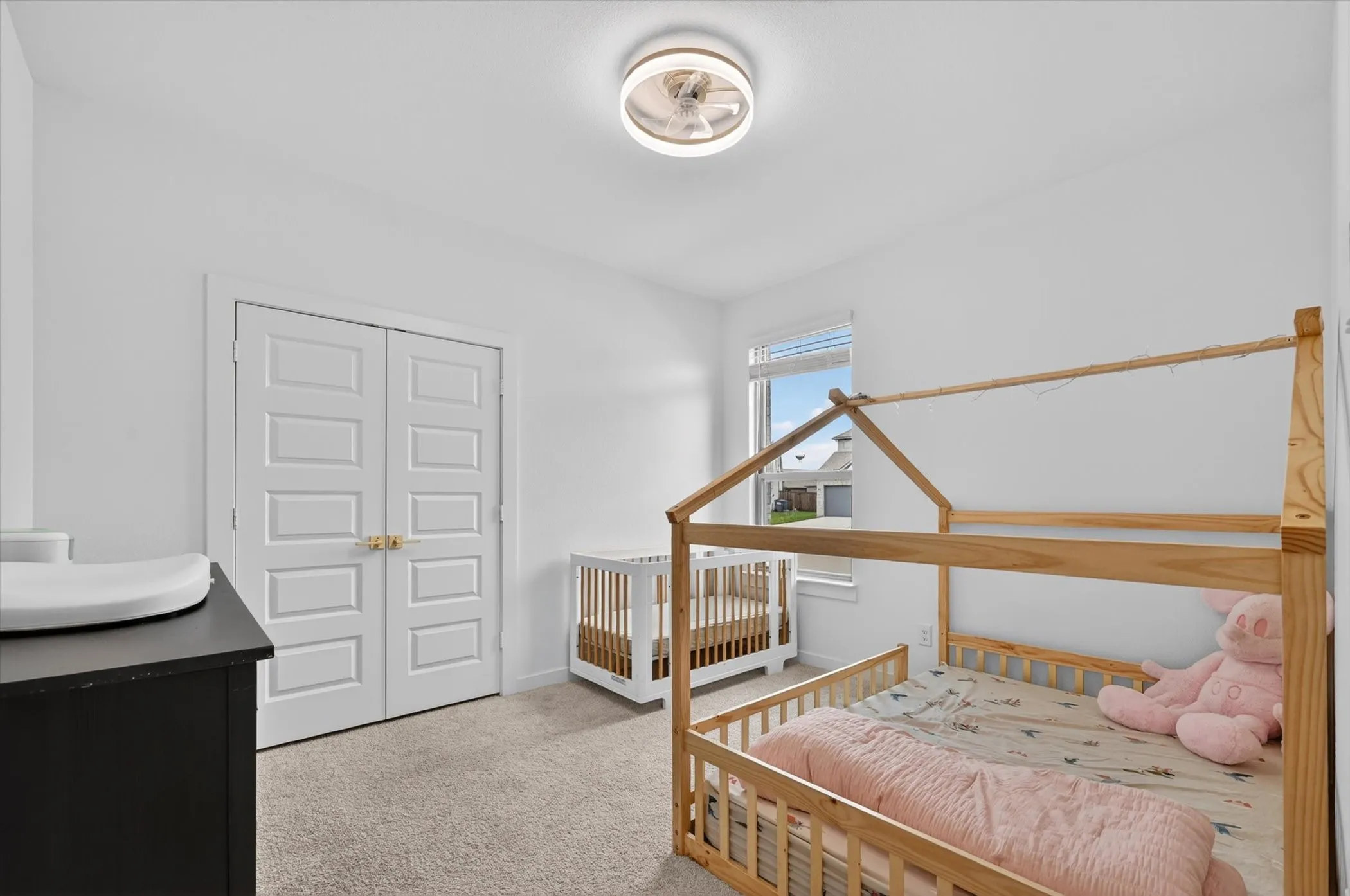 Neutral-toned carpeting complements the white walls and trim