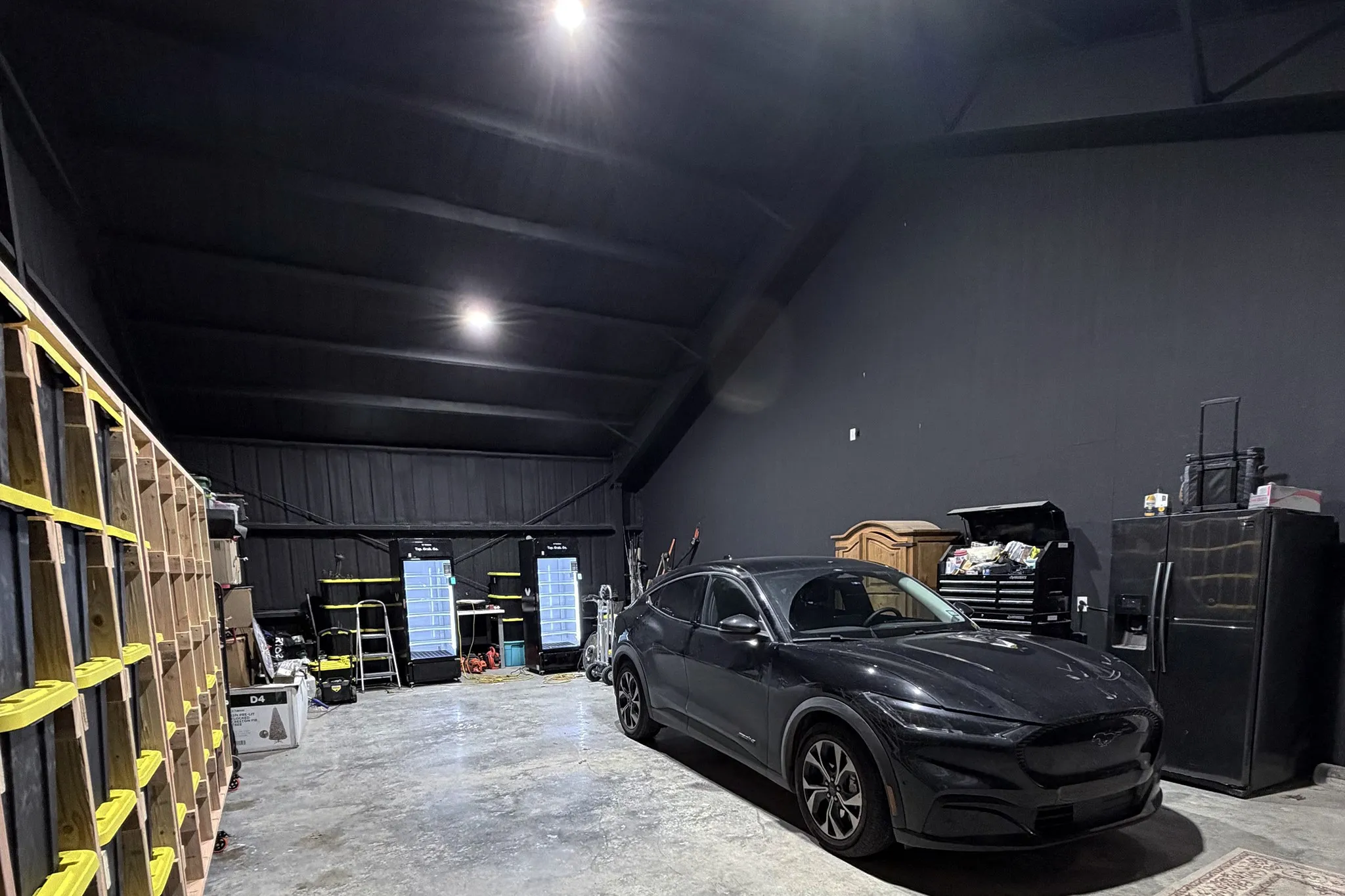 Oversized attached flexible garage/shop featuring a polished concrete floor and high vaulted ceilings.