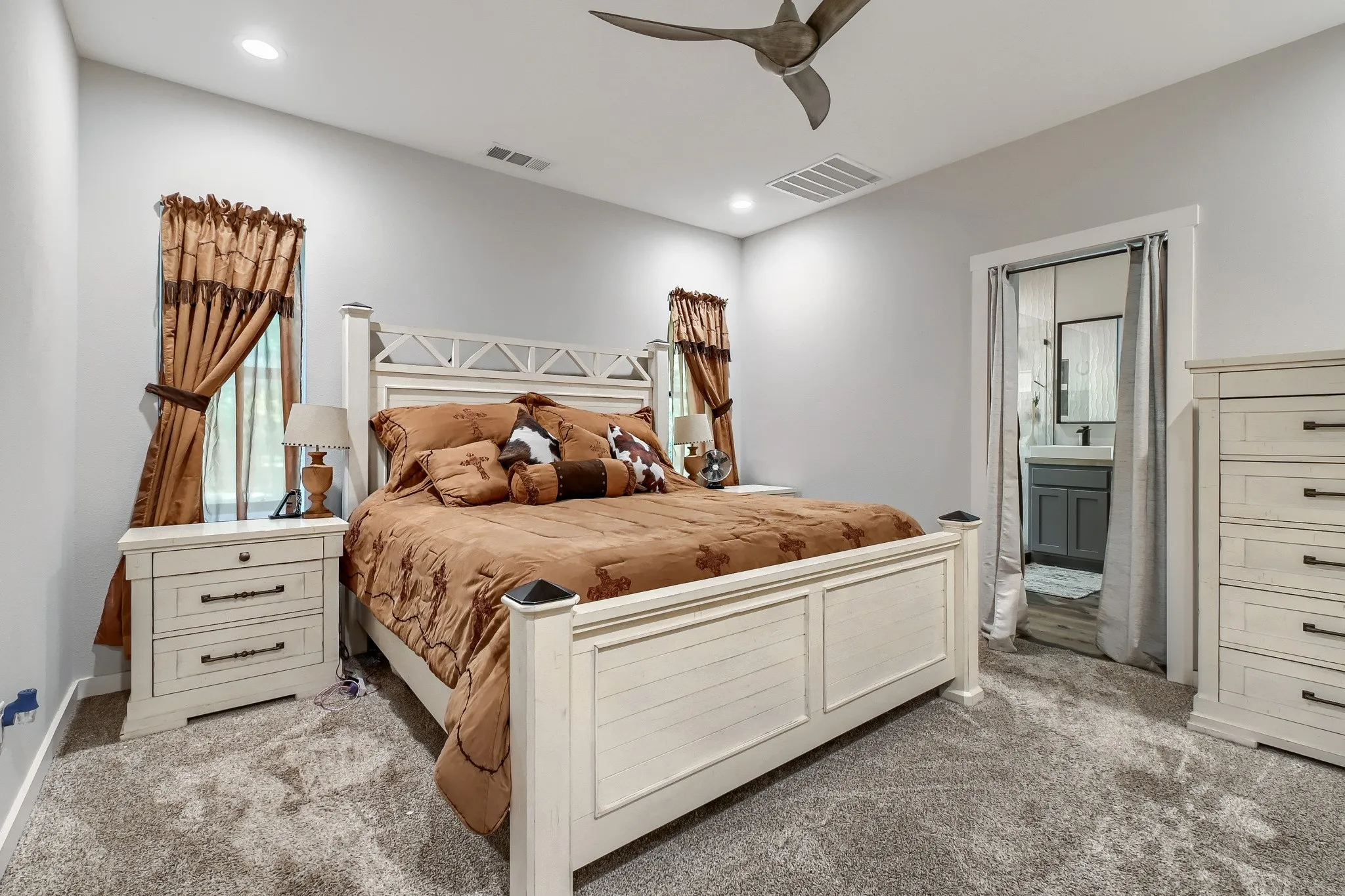 Primary bedroom with dual windows overlooking 5 private acres with direct access on ensuite bathroom.