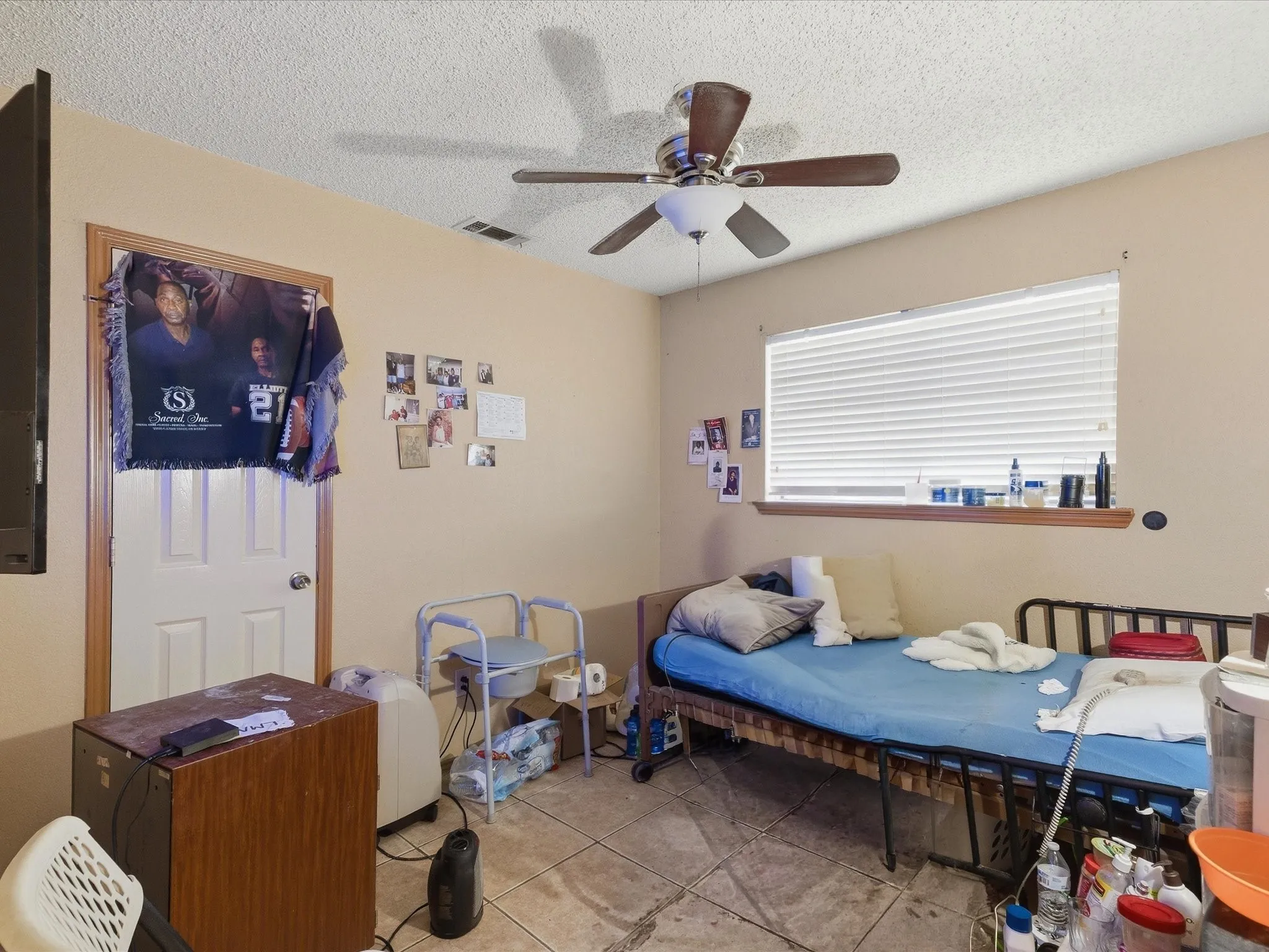 Room featuring tile flooring and a window with blinds