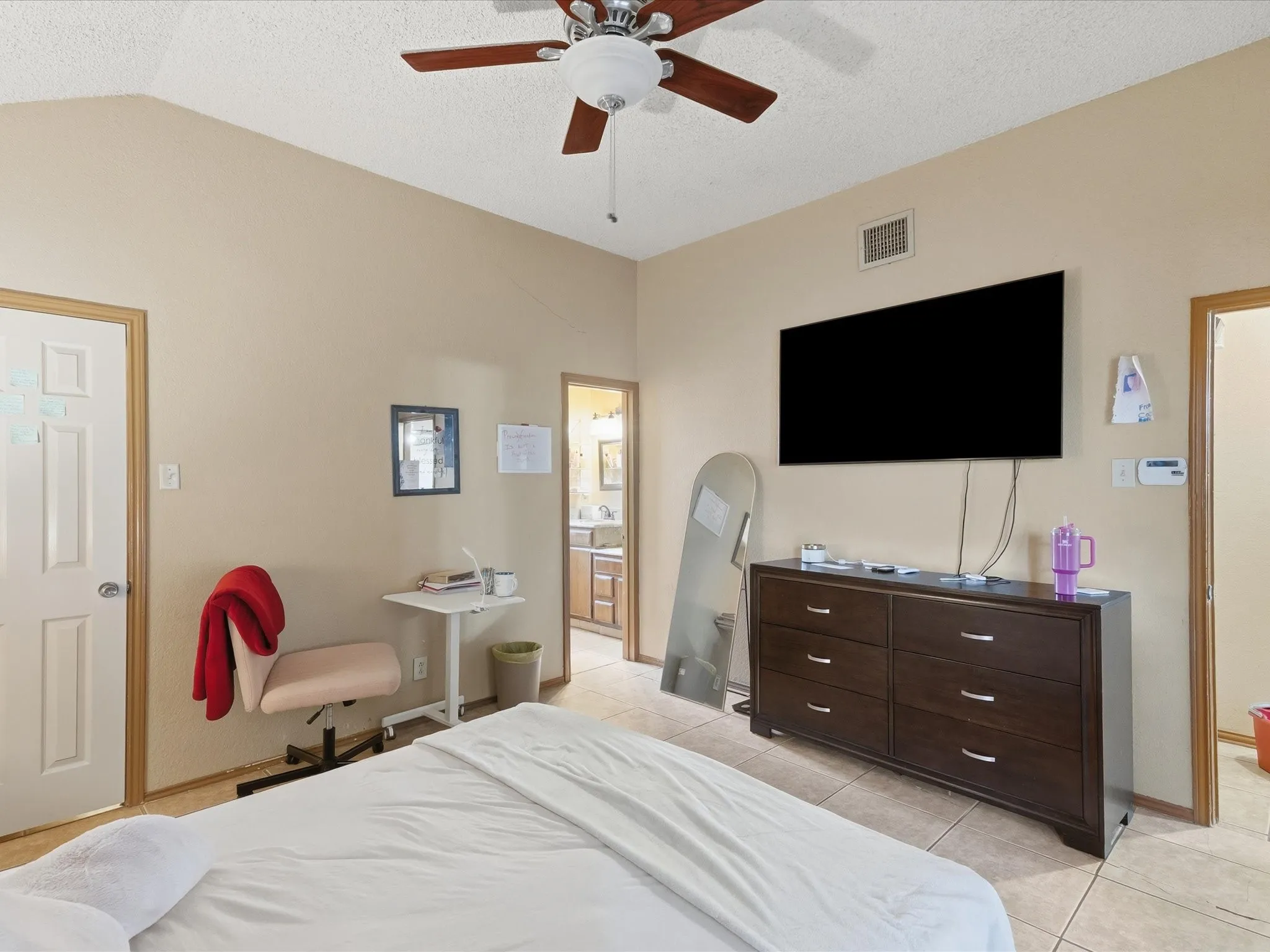 Room featuring vaulted ceilings and tile flooring