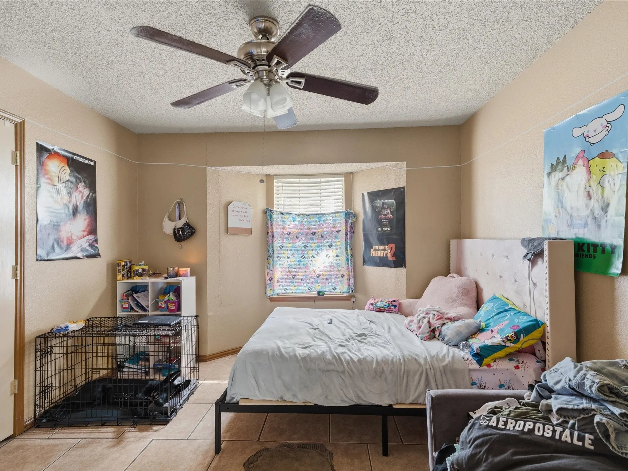 Bedroom featuring a ceiling fan with integrated lighting, a window with blinds, and tile flooring