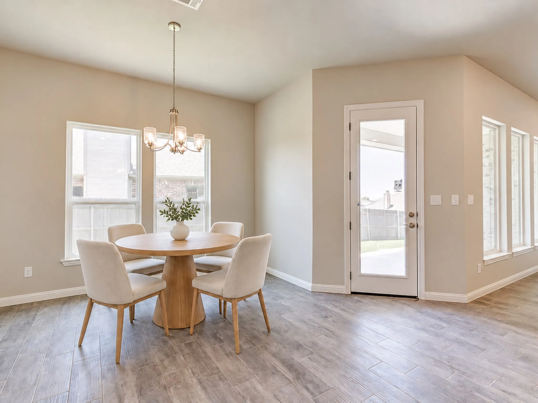 Recessed lighting complements a chandelier fixture