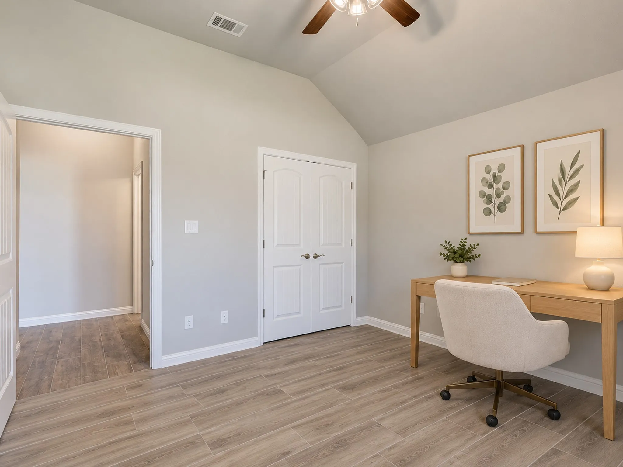 Vaulted ceiling with a ceiling fan, light gray wall paint, wood-finish tile flooring, white double doors, and white trim