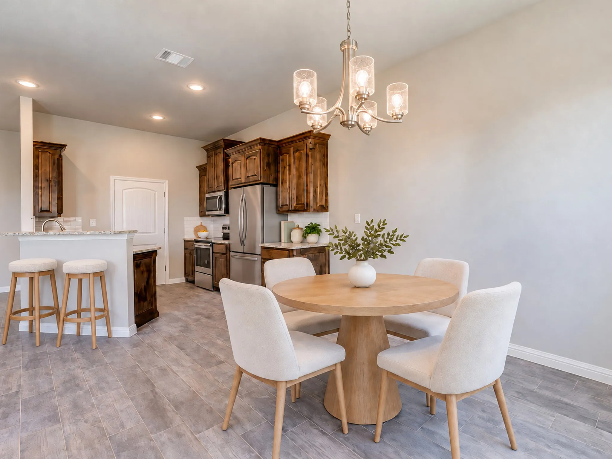 Open-concept kitchen and dining area featuring wood-finish flooring