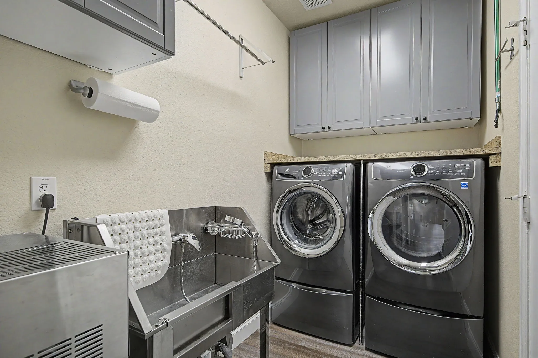 Laundry features dog built in dog wash station, bu8ilt in cabinets, Distilled water system and front load washer and dryer