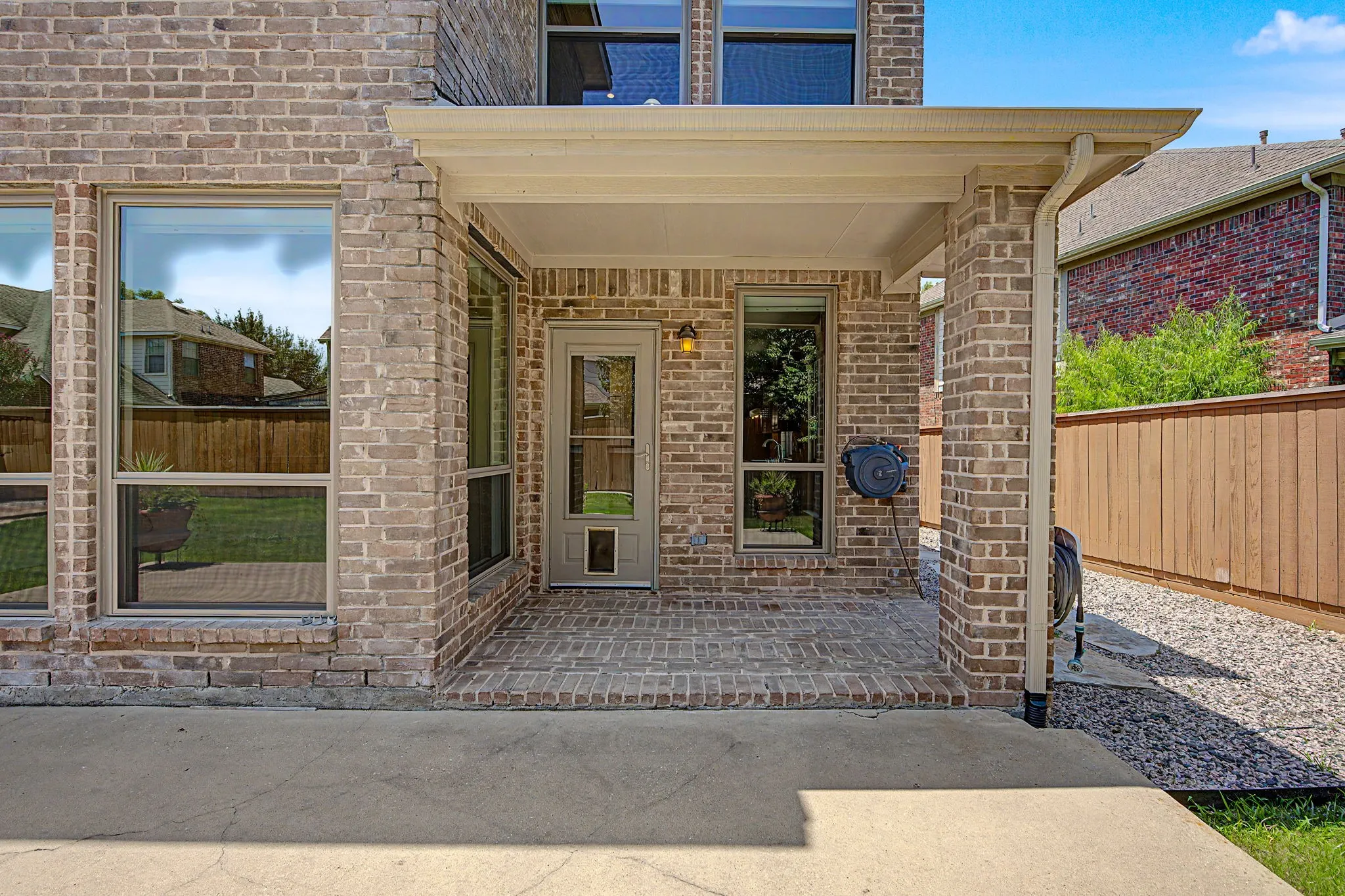 Covered patio is great for sitting and watching the birds or the kids, Backdoor equipped with doggy door and screen door