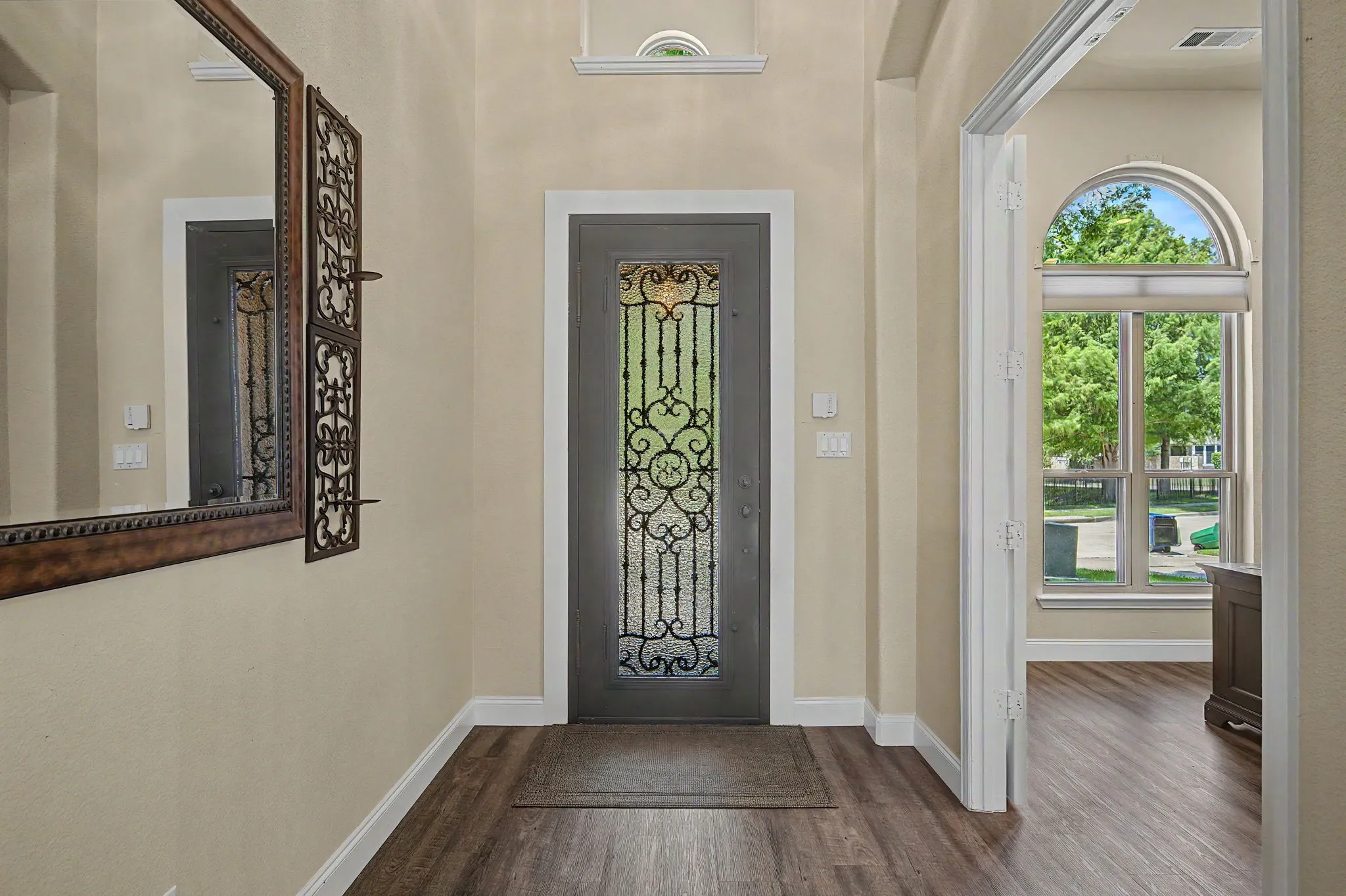 Beautiful Iron door installed in 2023, sets this entry apart from others!