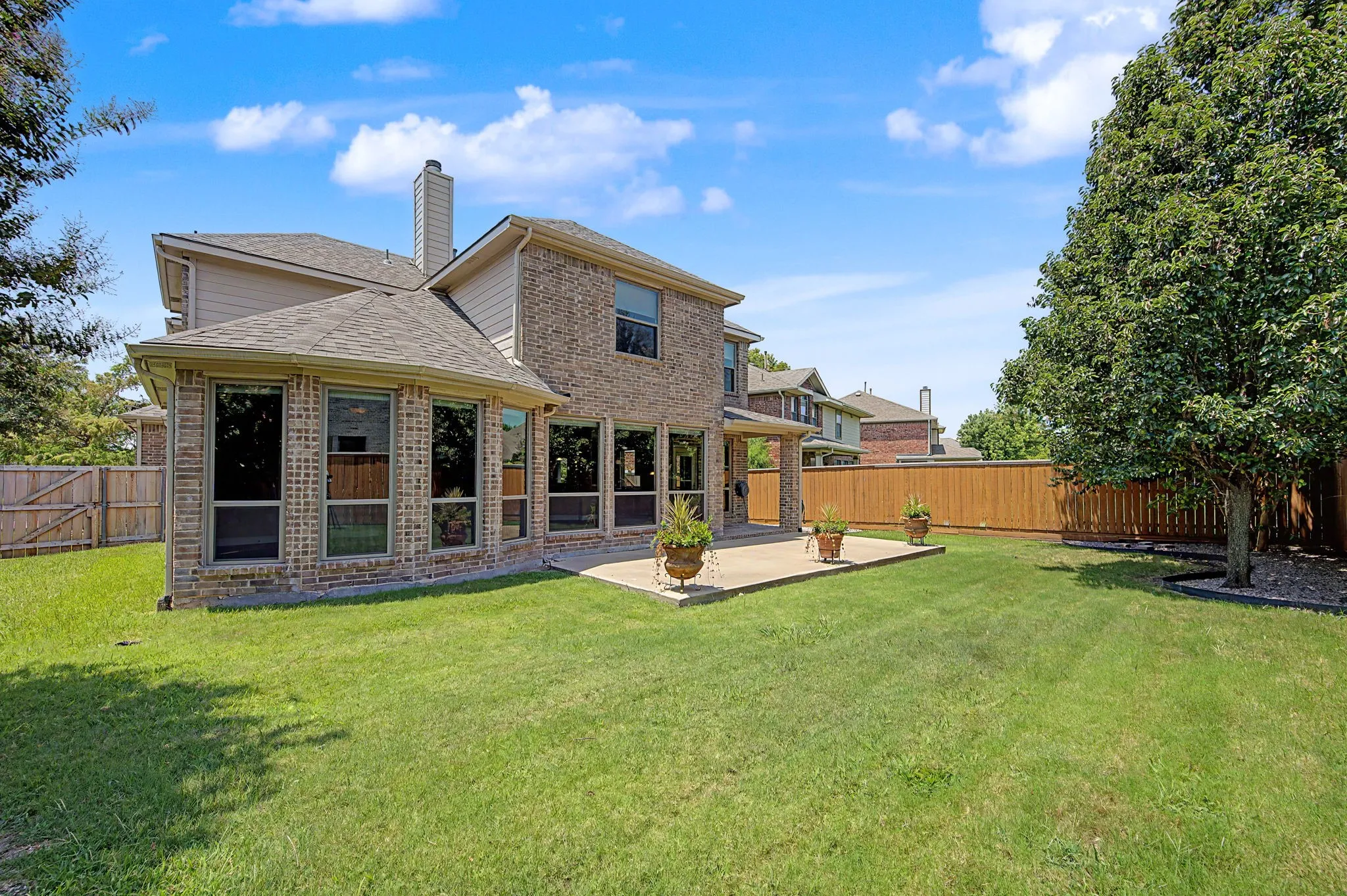 Nice sized backyard for the neighborhood, fully grassed with mature trees