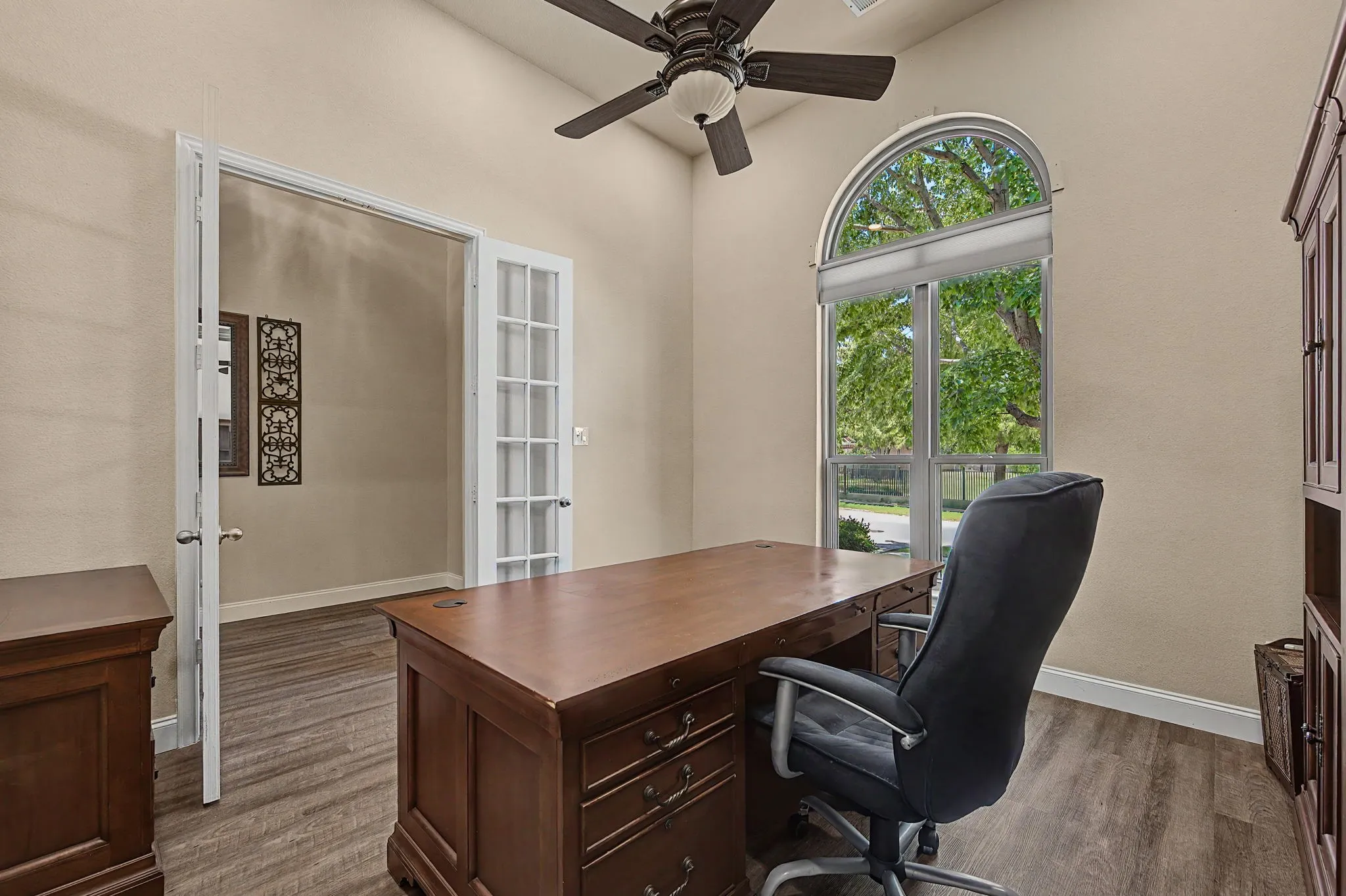 Large window with motorized shade offers privacy when desired and the large tree out front offers shade